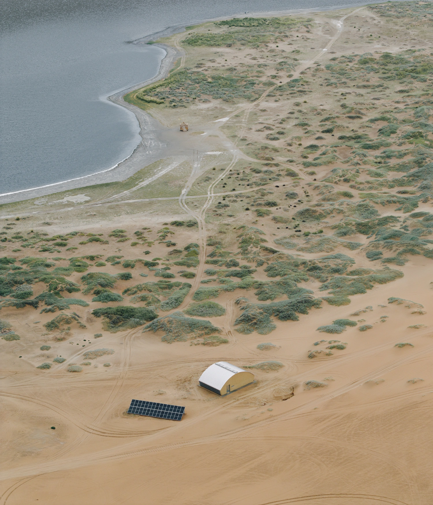Home in the Badain Jaran Desert by School of Architecture and Urban Planning NJU — Aerial view of the desert installation revealing the project's minimal footprint within the Badain Jaran landscape.