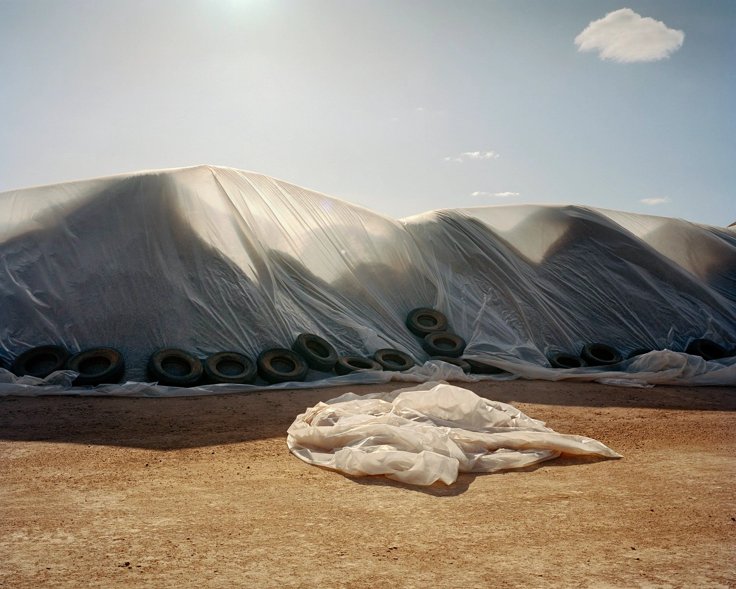 Big Sky by Adam Ferguson — Adam Ferguson documents agricultural infrastructure across Australian inland territories, capturing industrial-scale storage systems anchored with recycled...