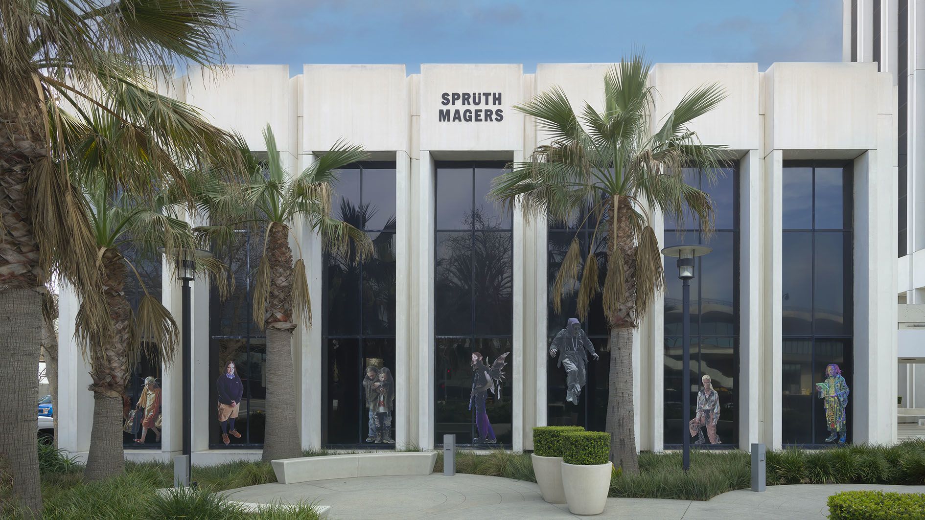 Proof of Concept by Jon Rafman at Sprüth Magers LA — The storefront of Sprüth Magers LA presents a monolithic white facade with recessed vertical pilasters framing large glass windows.
