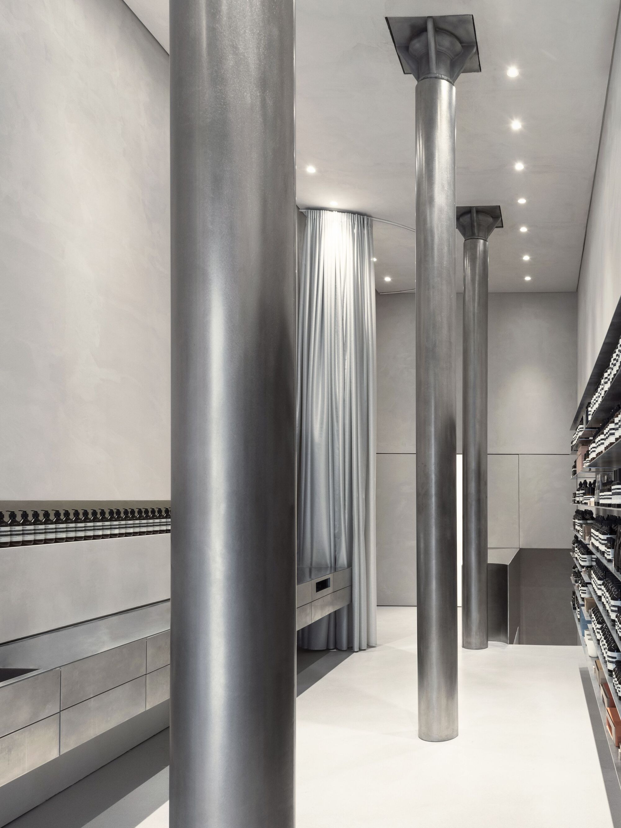 Aesop Store Barcelona by BAROZZI VEIGA — Interior view of the Aesop store revealing the structural framework supporting the retail space.