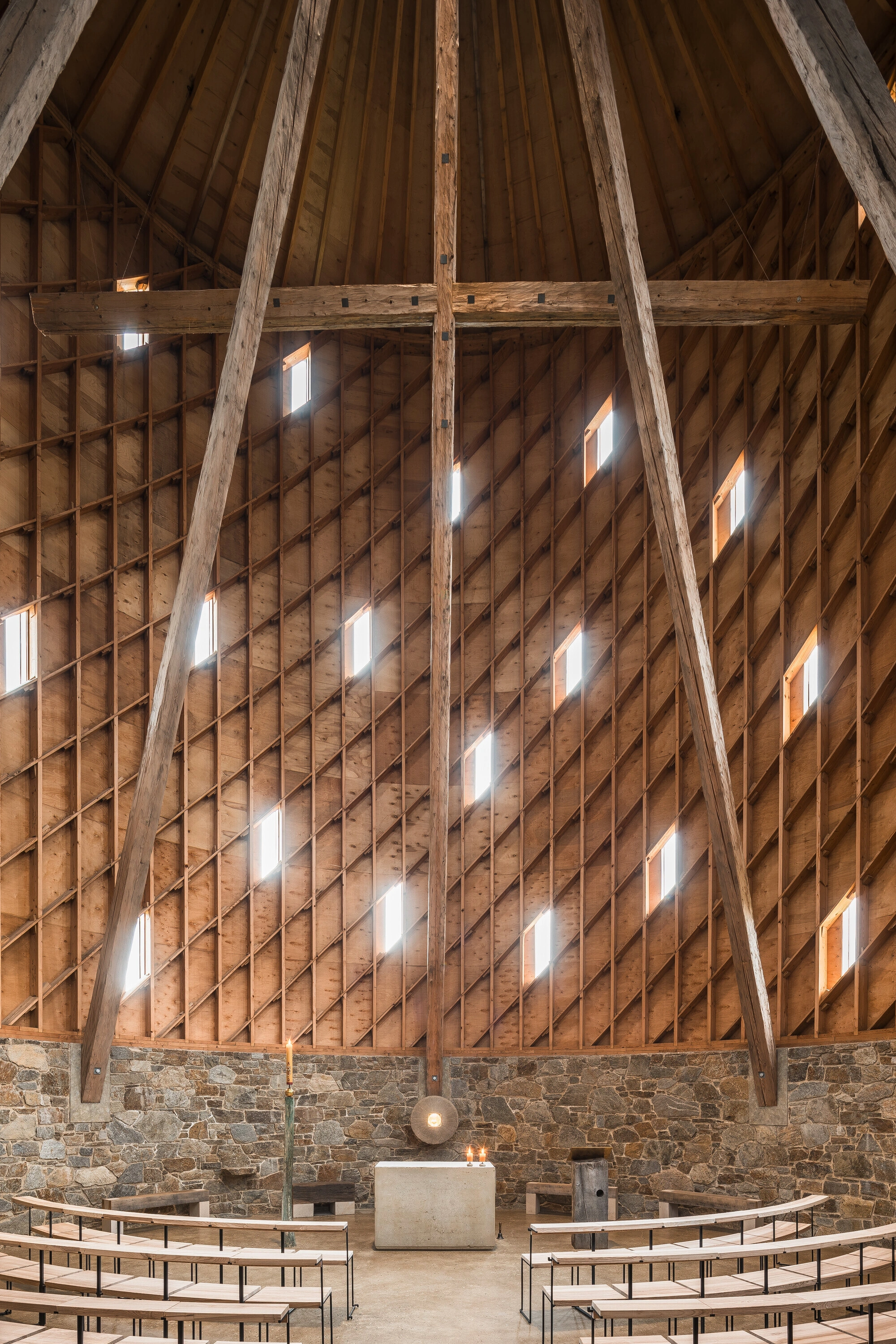 Our Lady of Sorrows Chapel by RCNKSK — Interior view of the chapel vault capturing the geometric timber structure in sharp relief.