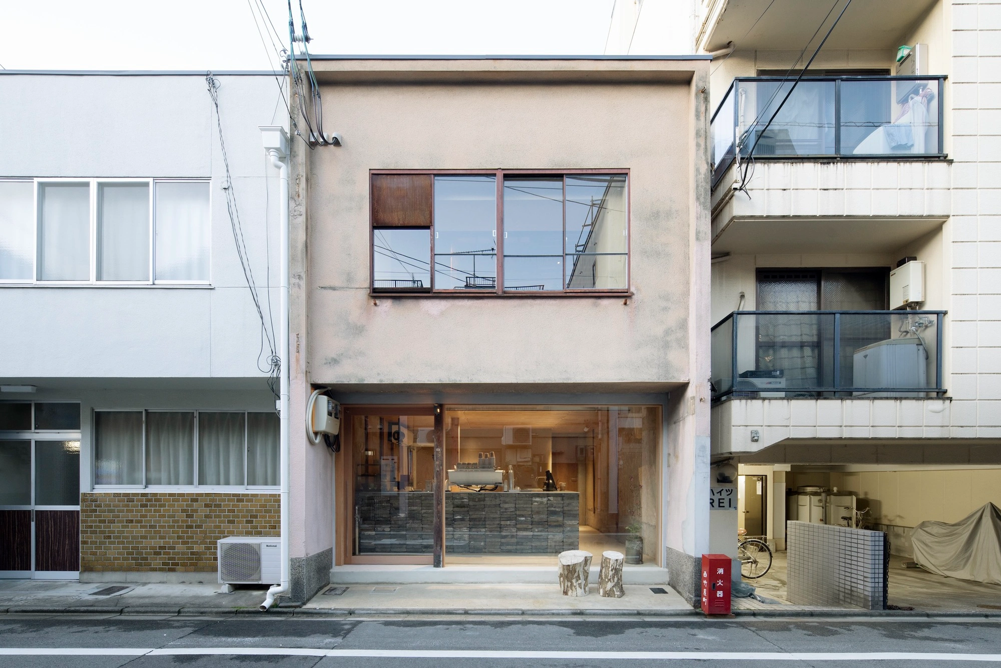HOO Cafe Kyoto by Koyori Architects — A narrow Kyoto machiya storefront presents a studied contrast between exterior decay and interior warmth.