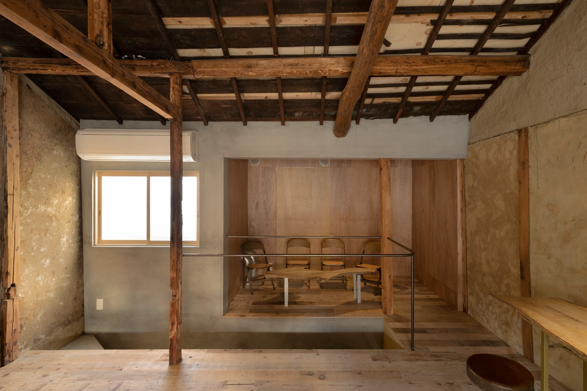 HOO Cafe Kyoto by Koyori Architects — Interior view of the adaptive reuse café revealing the structural post-and-beam framework of the traditional Kyomachiya.