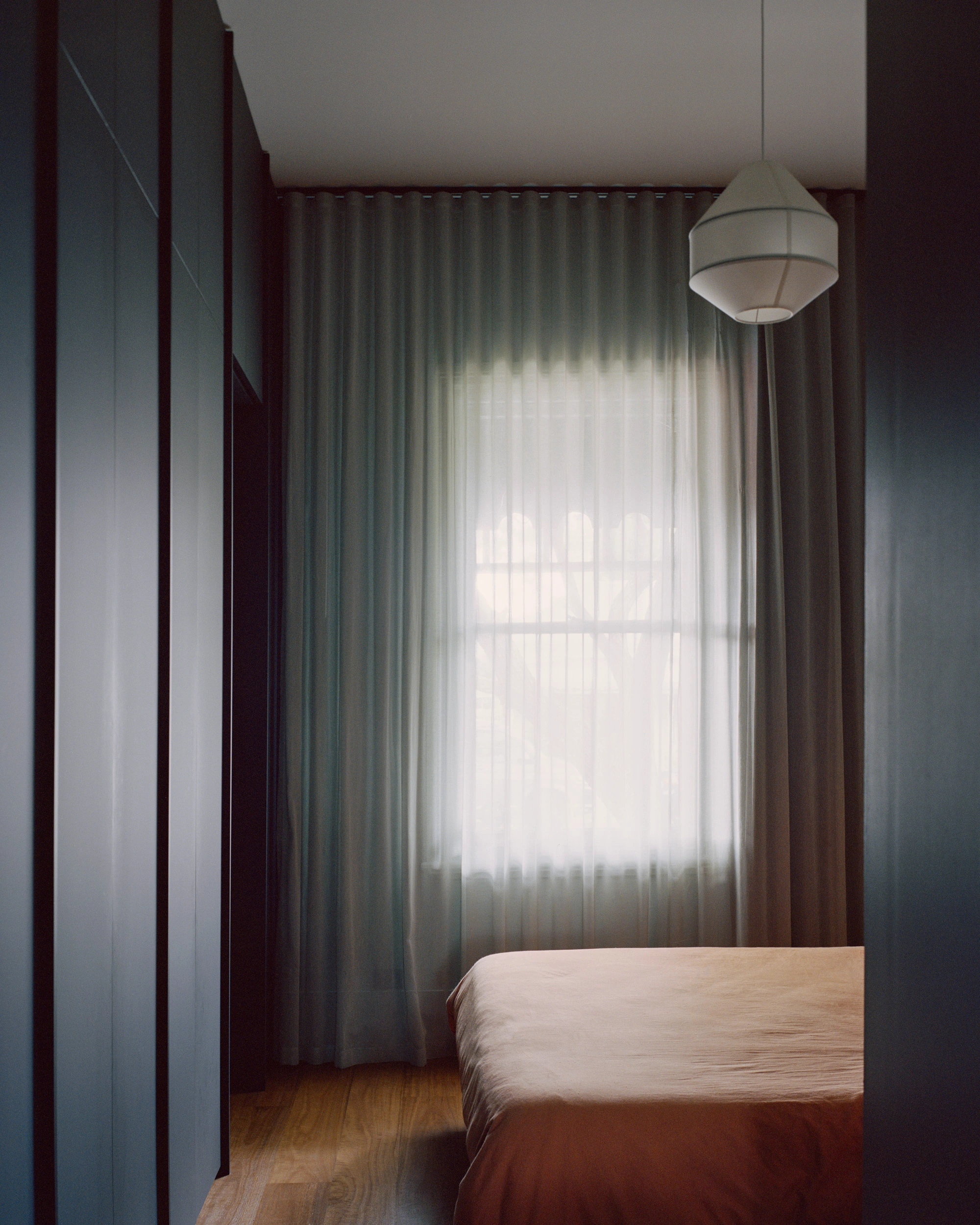 House K by Kart Projects — A bedroom corner within House K's lean extension captures the spatial choreography of light and materiality central to the project's design strategy.