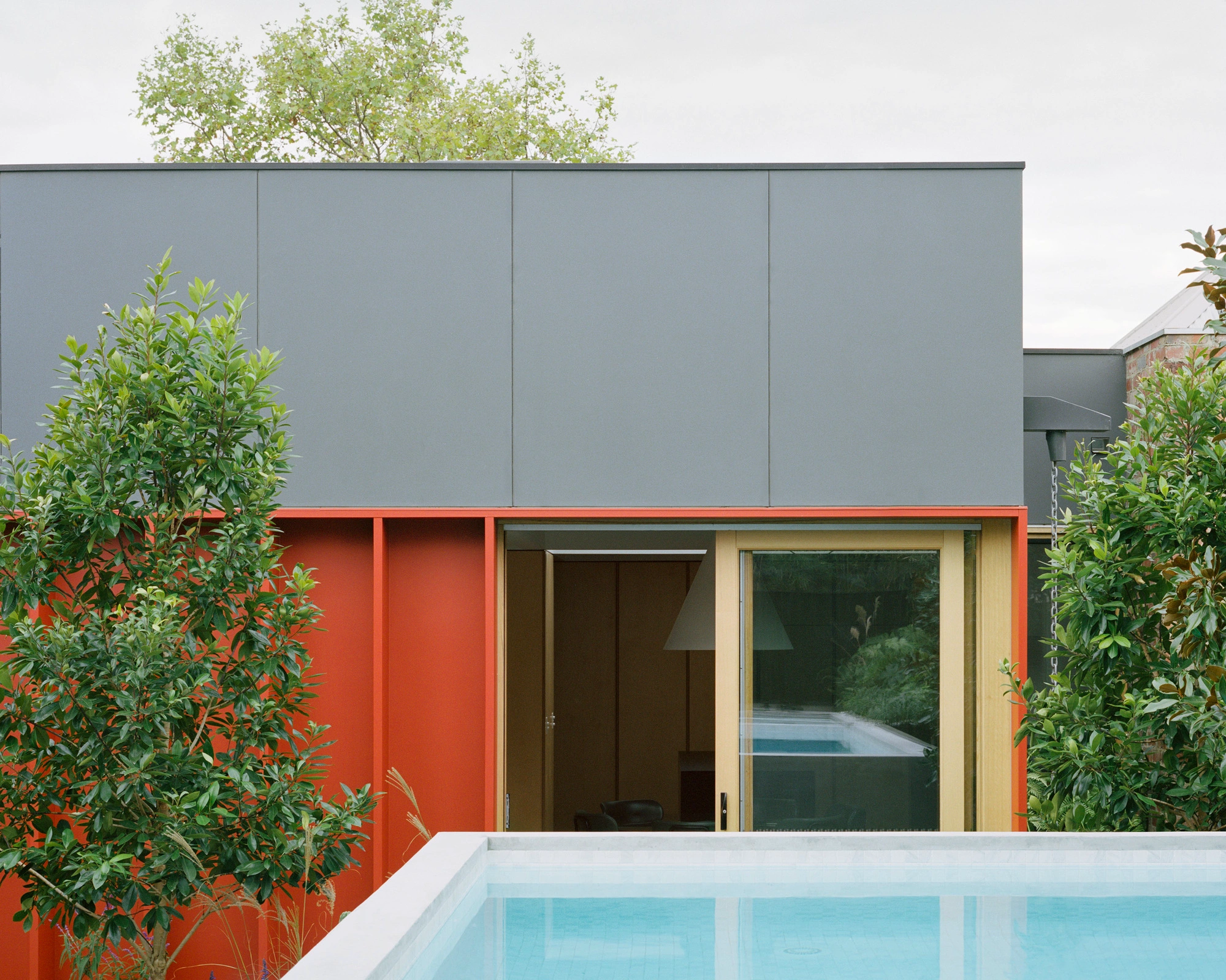 House K by Kart Projects — House K's lean extension reveals itself through layered materiality and chromatic contrast.