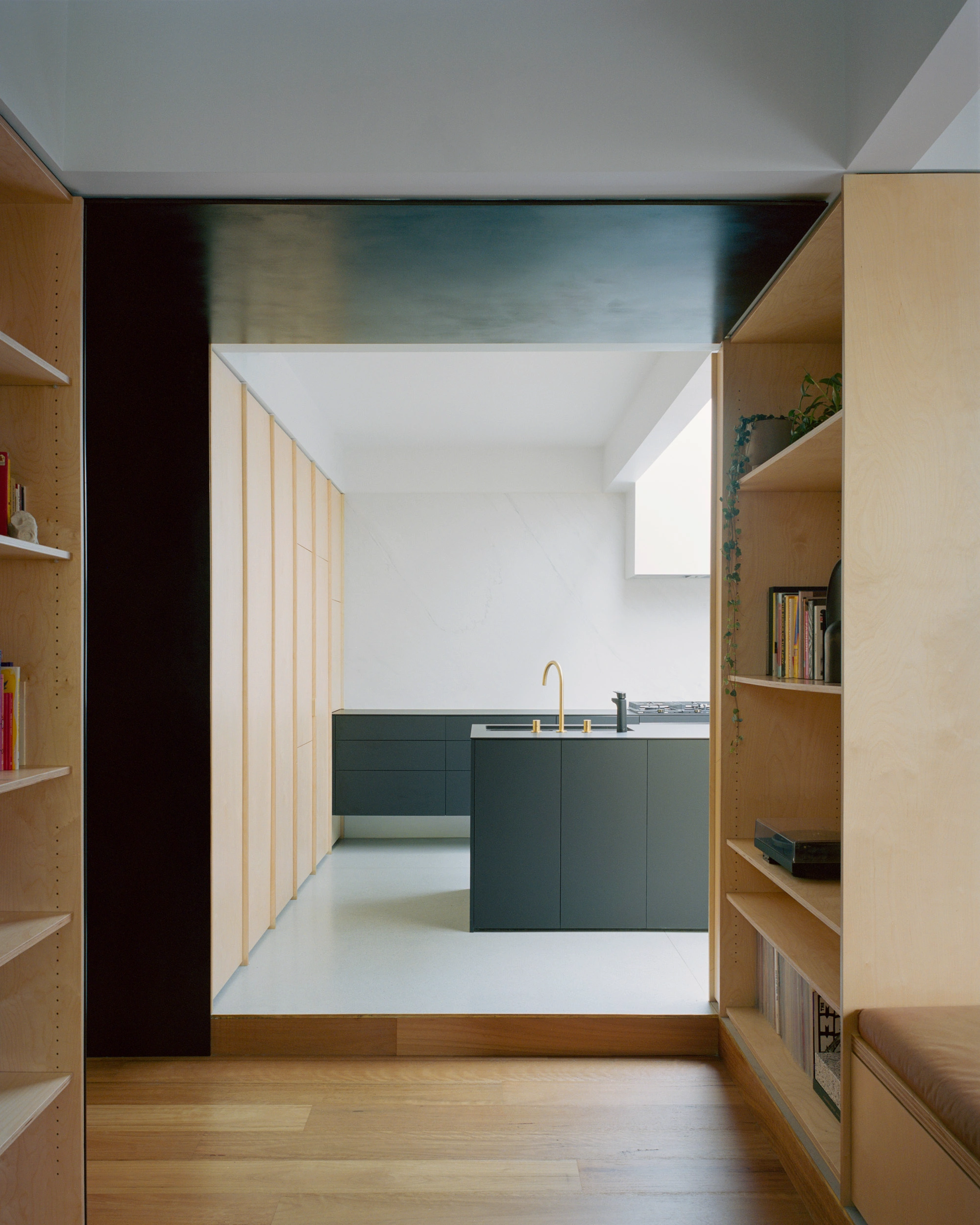 House K by Kart Projects — A threshold view into House K's extension reveals the careful material stratification that defines the addition.