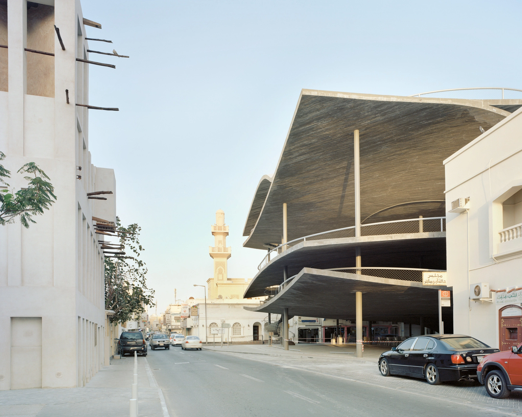 Pearling Path's Four Car Parks by Christian Kerez — Christian Kerez's car park structure dominates the medieval streetscape of Muharraq with a cantilevered pitched roof that extends dramatically over the...