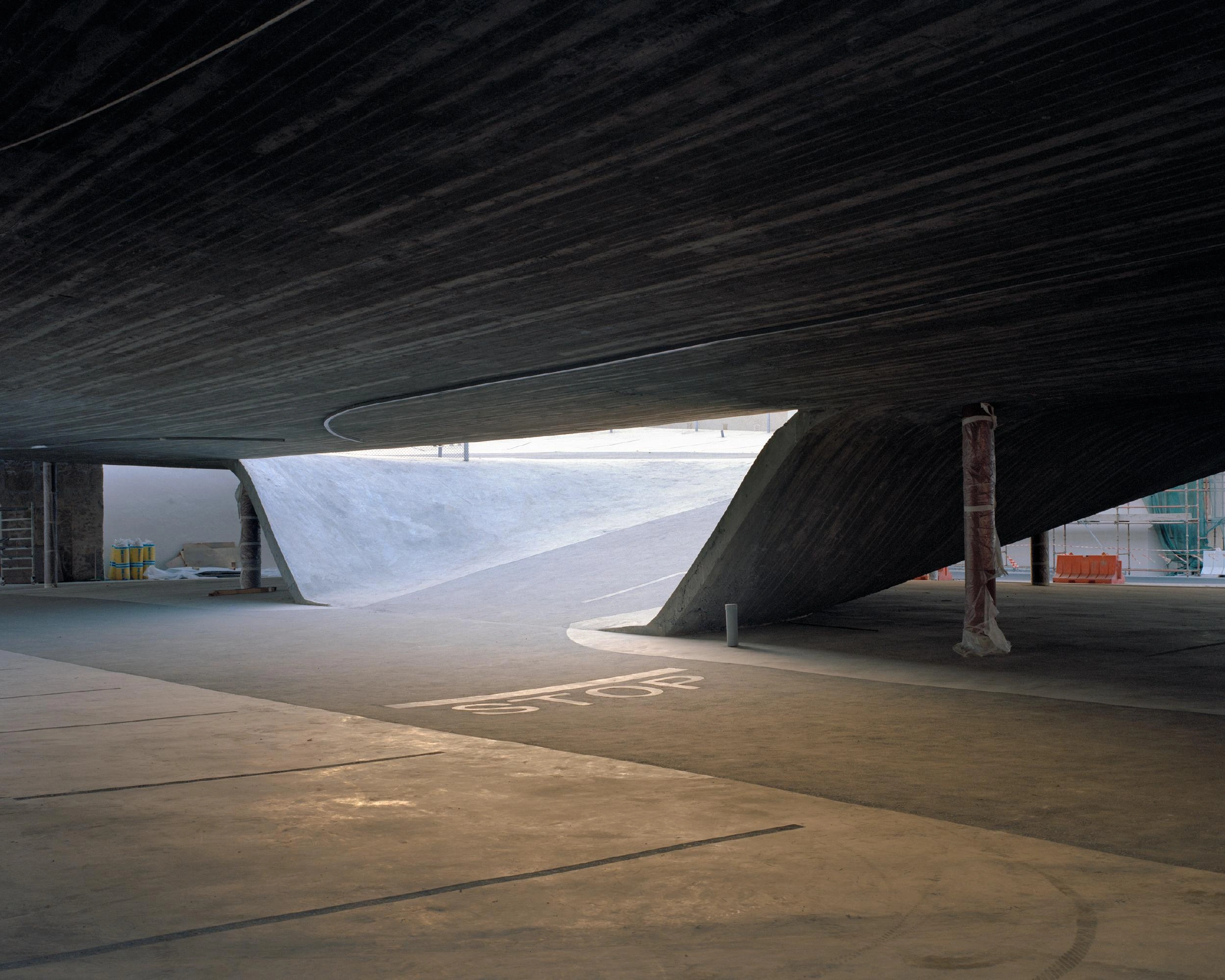 Pearling Path's Four Car Parks by Christian Kerez — The ground-level plaza beneath the car park's cantilevered pitched roof reveals the structural logic of Kerez's design.