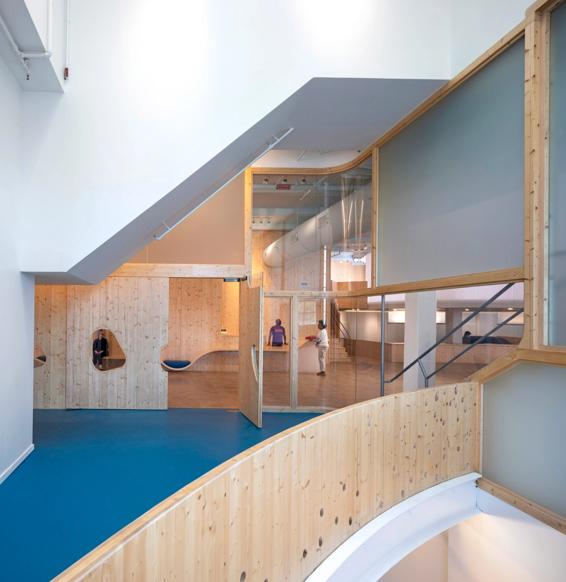 Bronx Children's Museum by O'Neill McVoy — A double-height gallery space within the historic Bronx Terminal Market Powerhouse frames a sculptural timber wall pierced by a spiral tunnel.