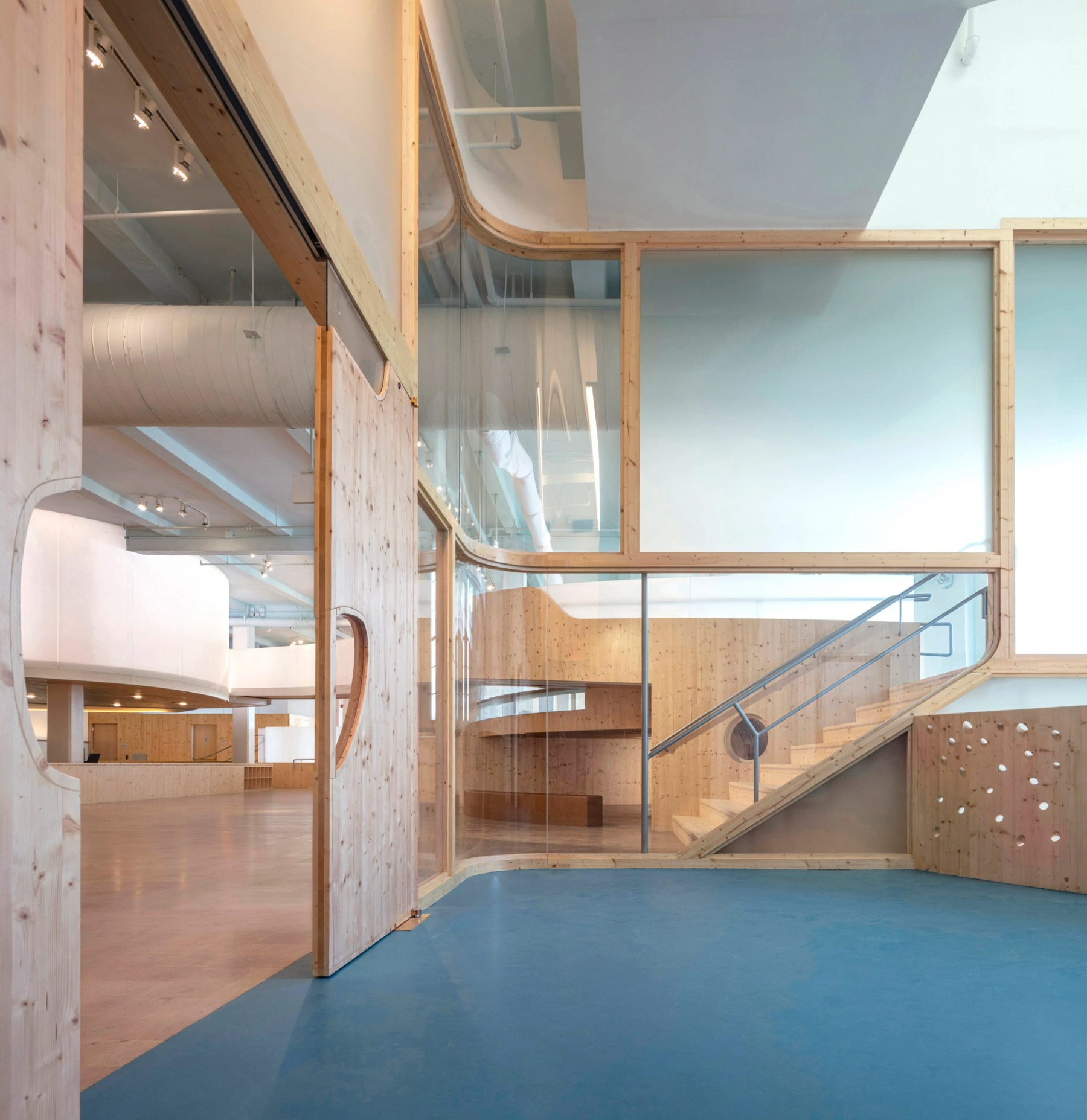 Bronx Children's Museum by O'Neill McVoy — A timber-lined threshold articulates the transition between gallery and sculptural void.