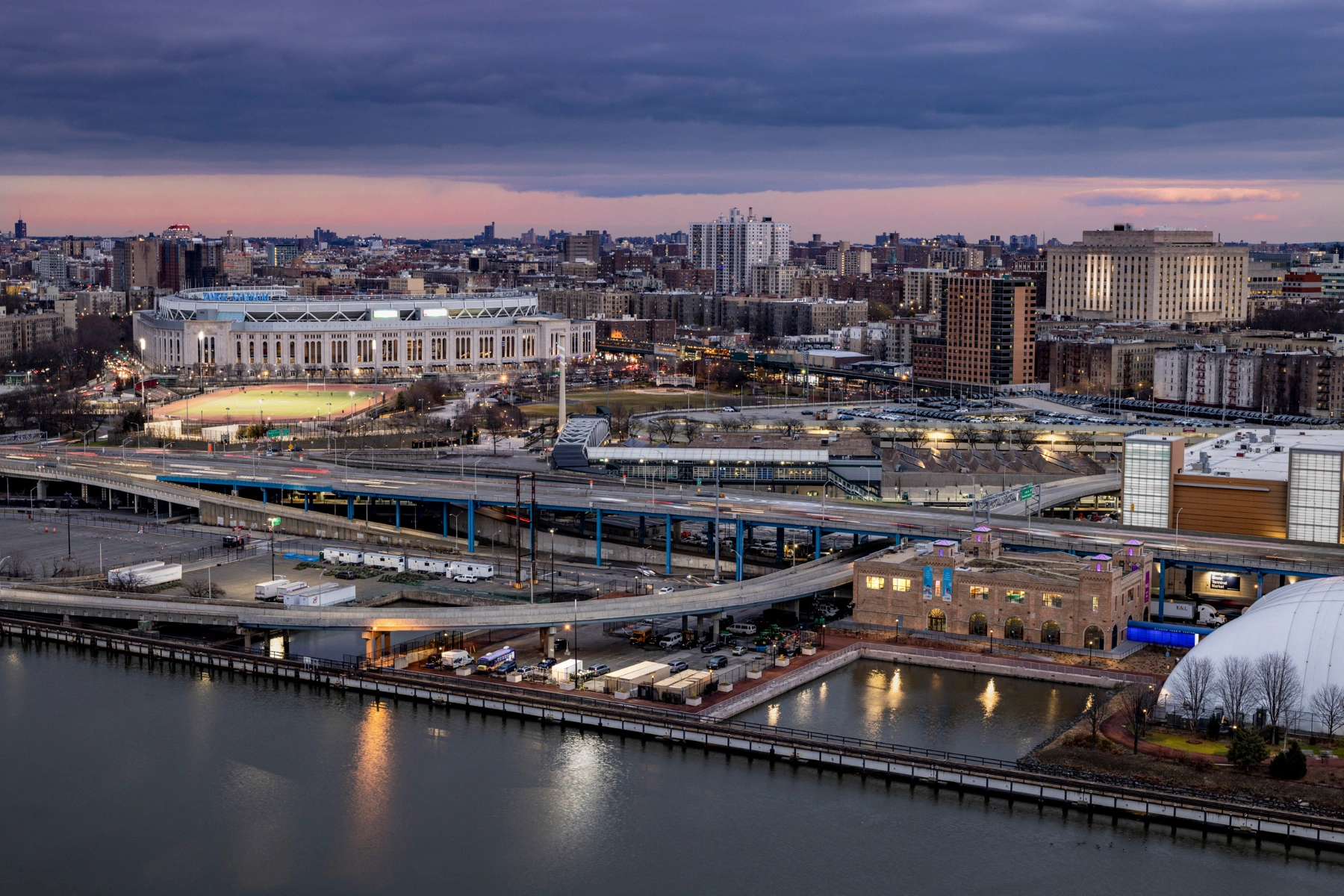 Bronx Children's Museum by O'Neill McVoy — Dusk aerial view of the Bronx Children's Museum situated within the historic 1925 Powerhouse, captured from across the Harlem River.