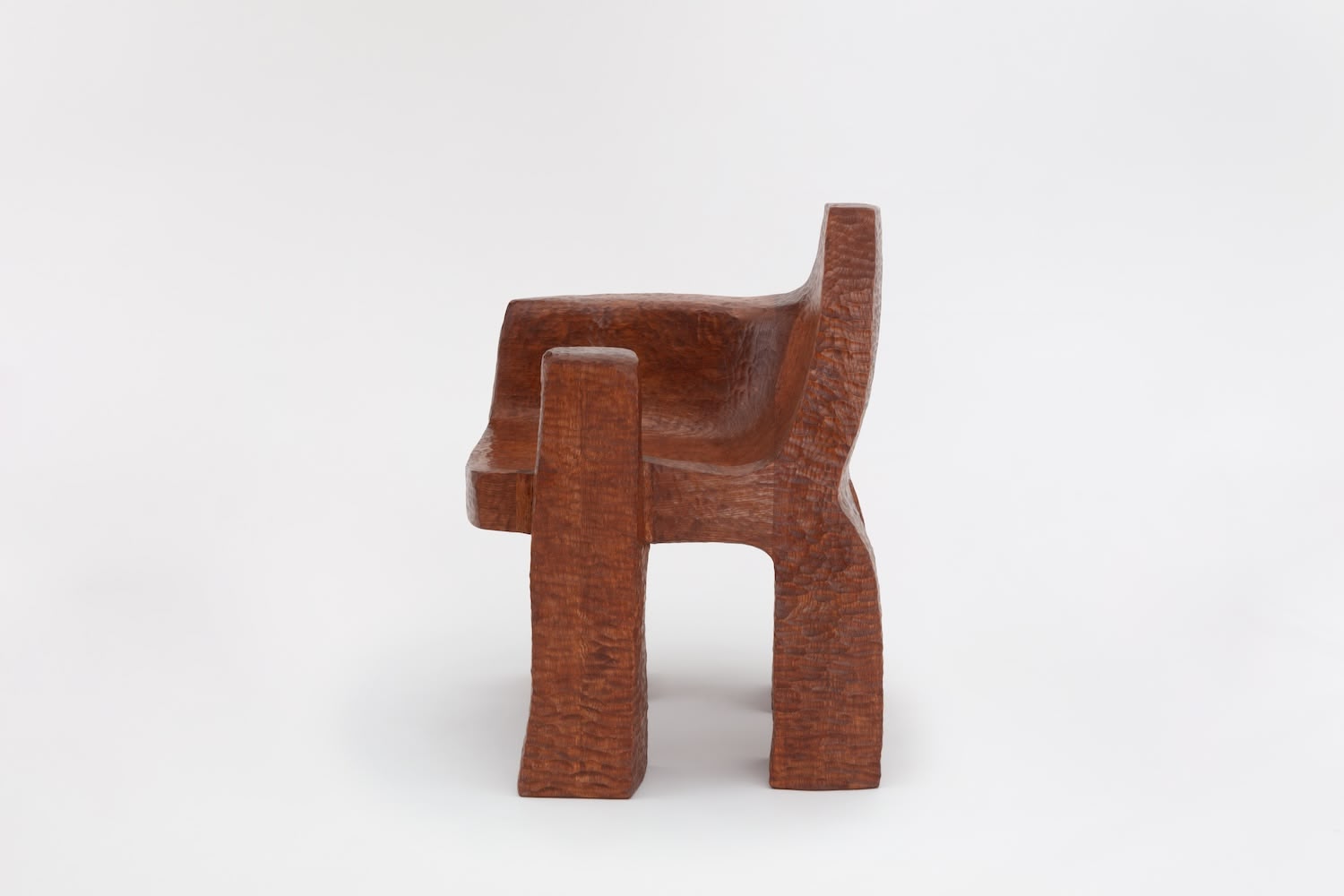 Cairn Chair by Faye Toogood — Hand-carved from solid English oak, the Cairn Chair presents a monolithic form with chunky rectangular legs and a deeply hollowed seat cavity featuring...