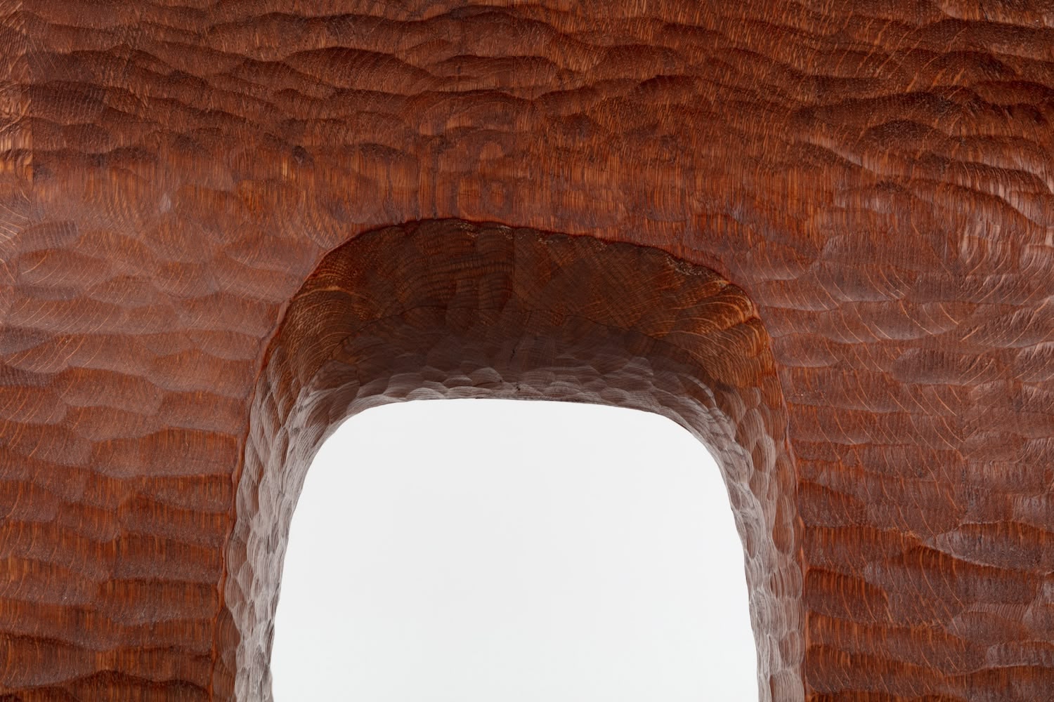 Cairn Chair by Faye Toogood — Close-up detail of the Cairn Chair's hand-carved seat cavity, revealing the sculptural interior of solid English oak.