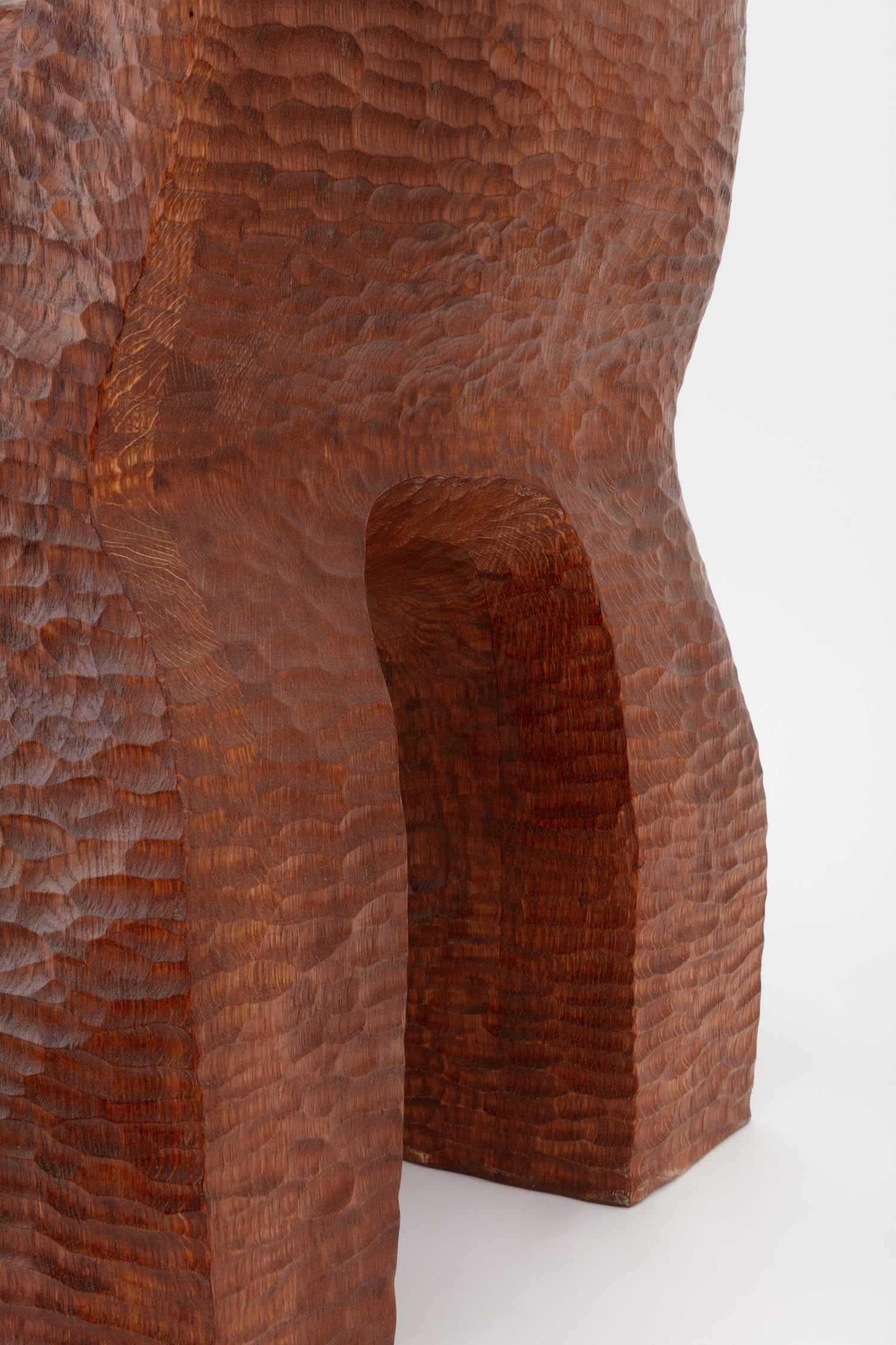 Cairn Chair by Faye Toogood — Detail photograph isolating the Cairn Chair's structural joint where a chunky rectangular leg meets the seat cavity.
