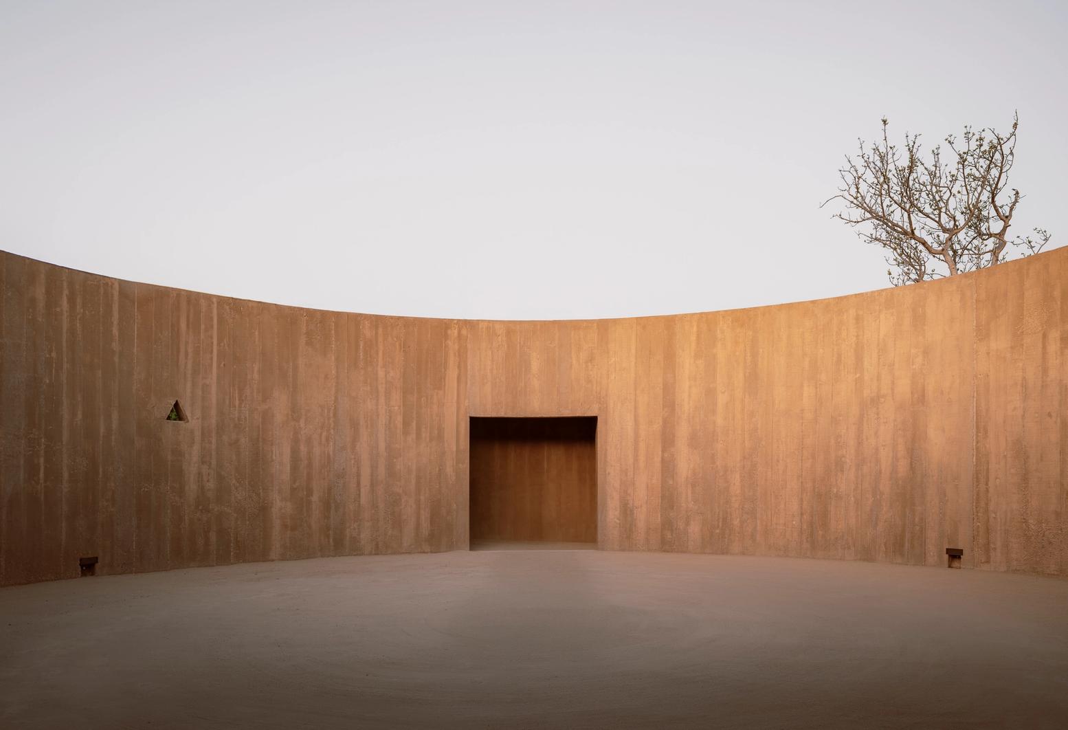 Spiritual Enclosure by Ruben Valdez — Spiritual Enclosure presents a monolithic concrete chamber defined by two curved walls forming a symmetrical composition.