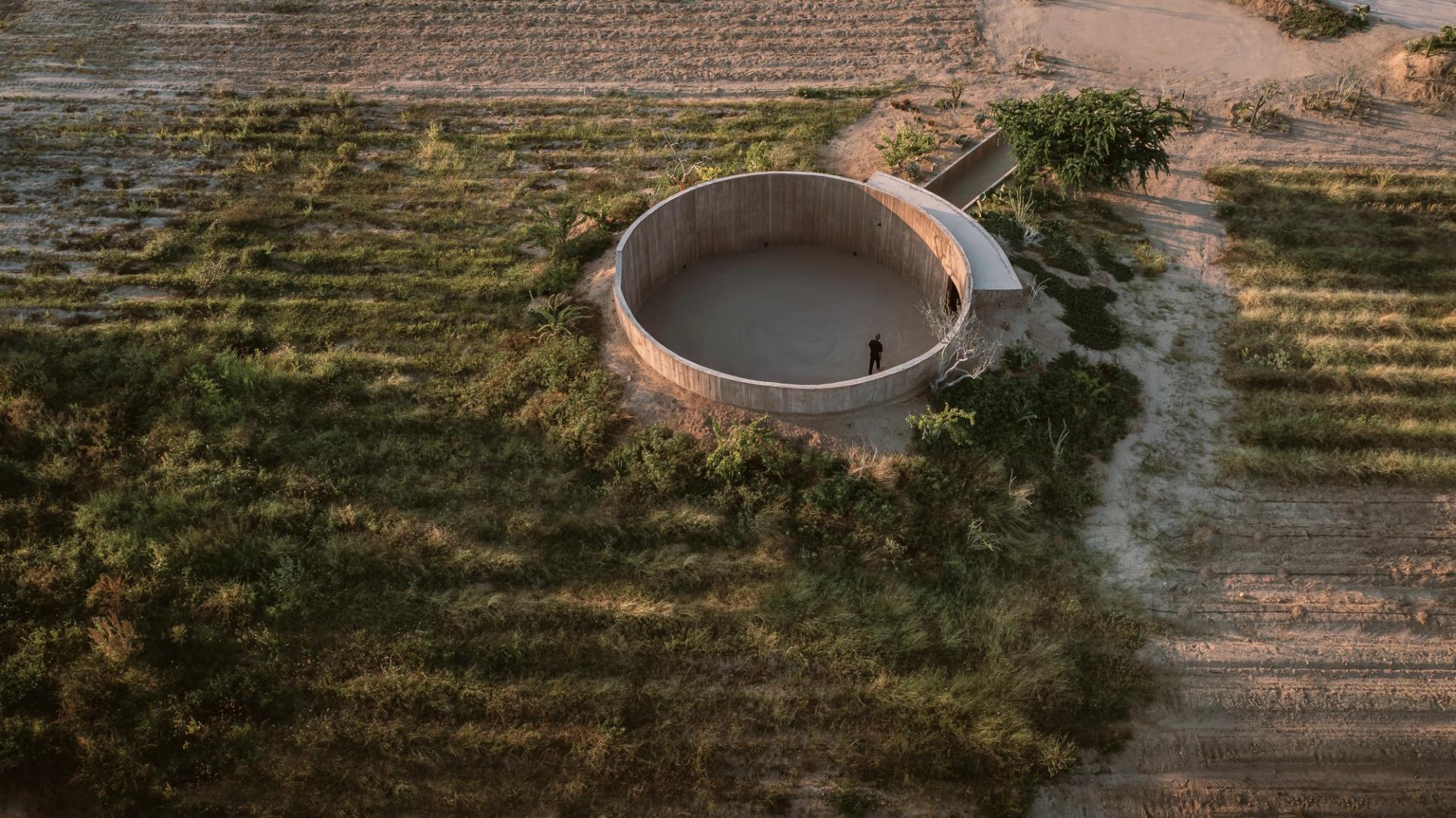 Spiritual Enclosure by Ruben Valdez — A monolithic concrete cylinder anchors the Baja California Desert landscape, its curved walls forming a semi-circular void that frames the distant horizon.