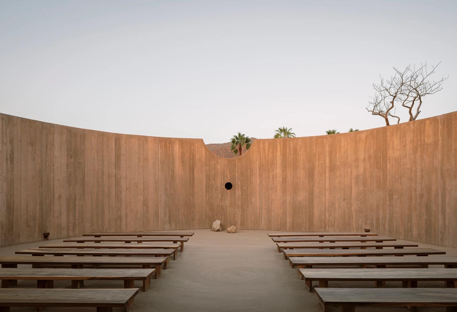 Spiritual Enclosure by Ruben Valdez — Spiritual Enclosure presents a symmetrical composition of monolithic concrete walls forming a semi-circular void that frames the distant mountain horizon.