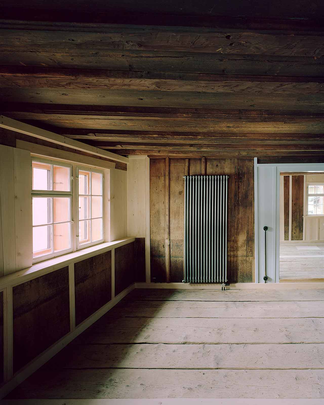 Mühle Ennenda by Atelier Lando Rossmaier — A timber-framed interior space reveals the accumulated evidence of structural adaptation.