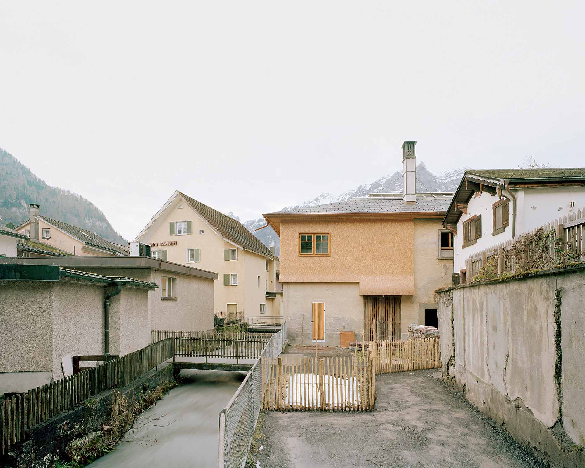 Mühle Ennenda by Atelier Lando Rossmaier — A courtyard view of the mill transformation reveals the project's archaeological approach to renovation.