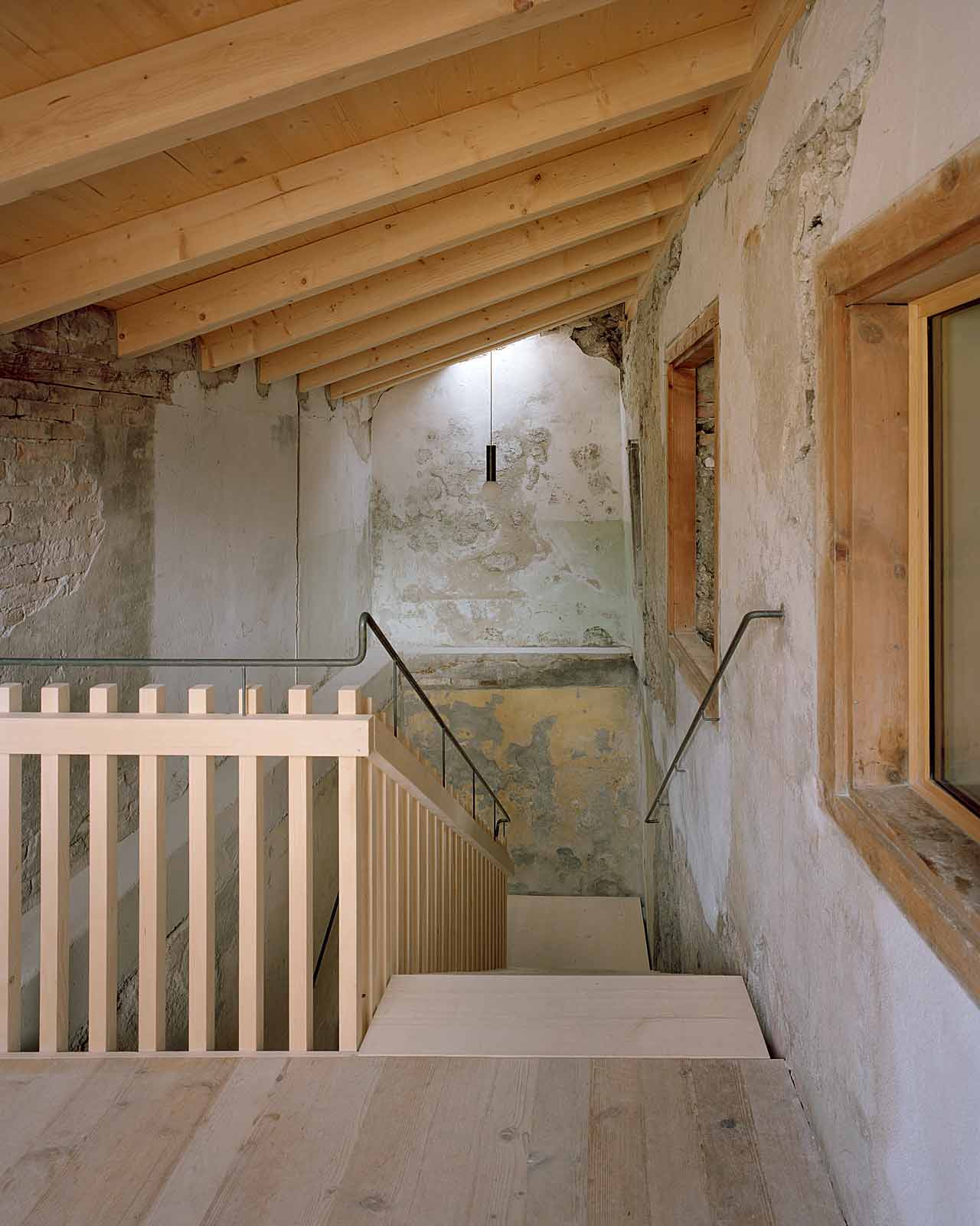 Mühle Ennenda by Atelier Lando Rossmaier — A timber-framed stairwell reveals the archaeological stratification of Mühle Ennenda's renovation.