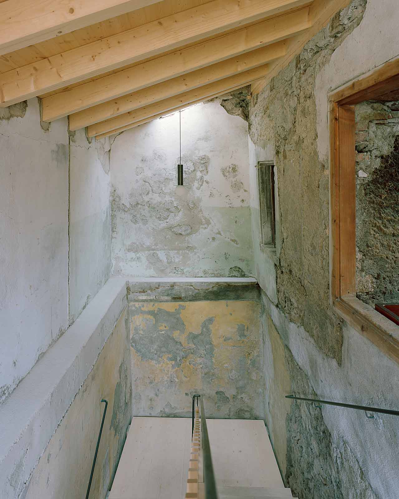 Mühle Ennenda by Atelier Lando Rossmaier — A narrow passage reveals the intervention's archaeological approach.