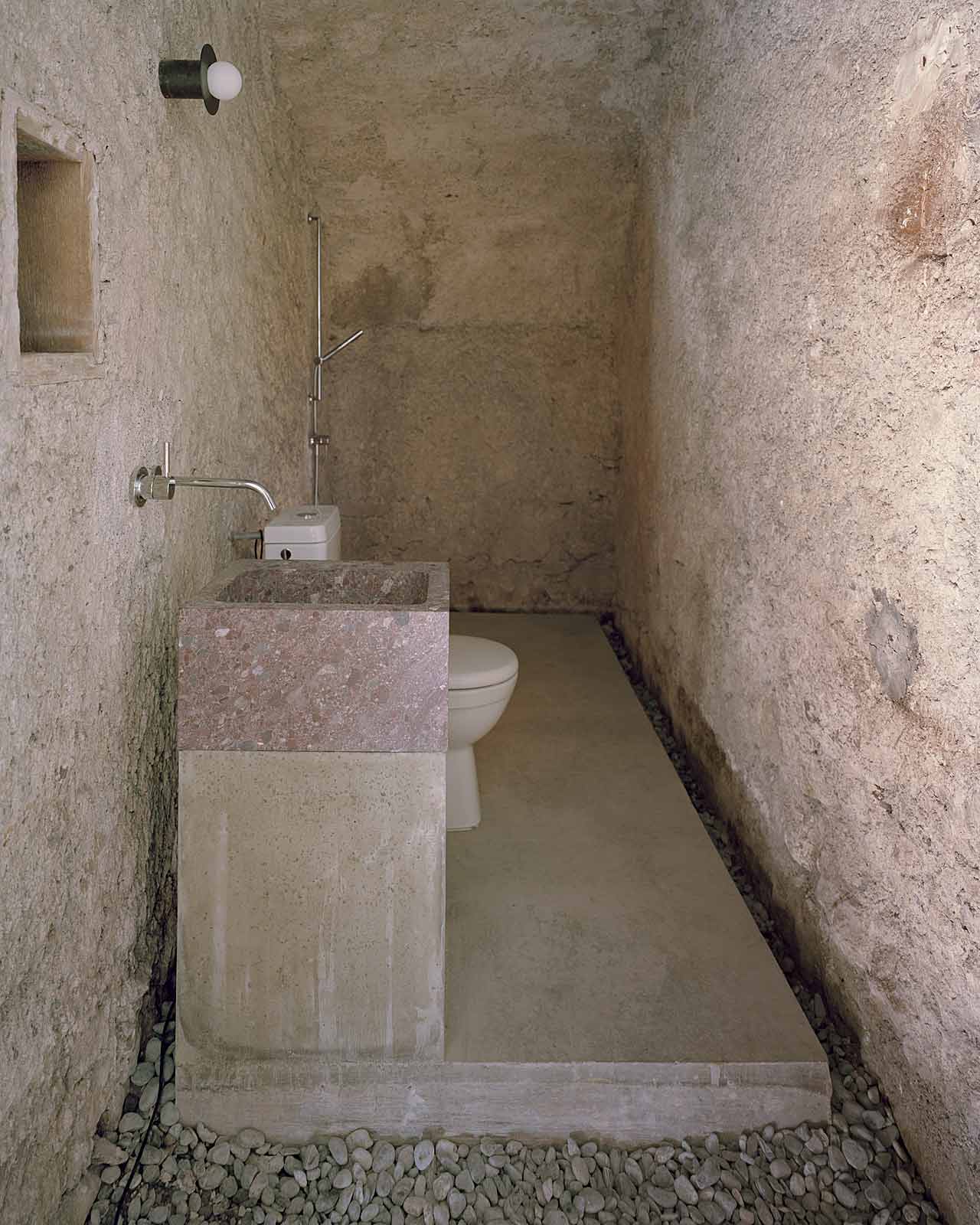 Mühle Ennenda by Atelier Lando Rossmaier — A narrow bathroom passage reveals the project's archaeological approach to material preservation.