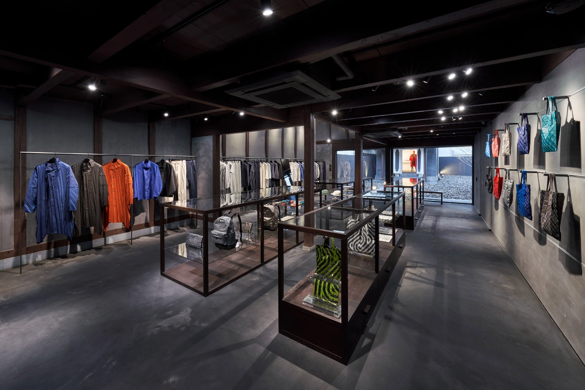 Issey Miyake Kyoto by Naoto Fukasawa Design — Interior view of the Issey Miyake Kyoto flagship, showcasing the minimalist retail environment defined by a charcoal and grey palette.