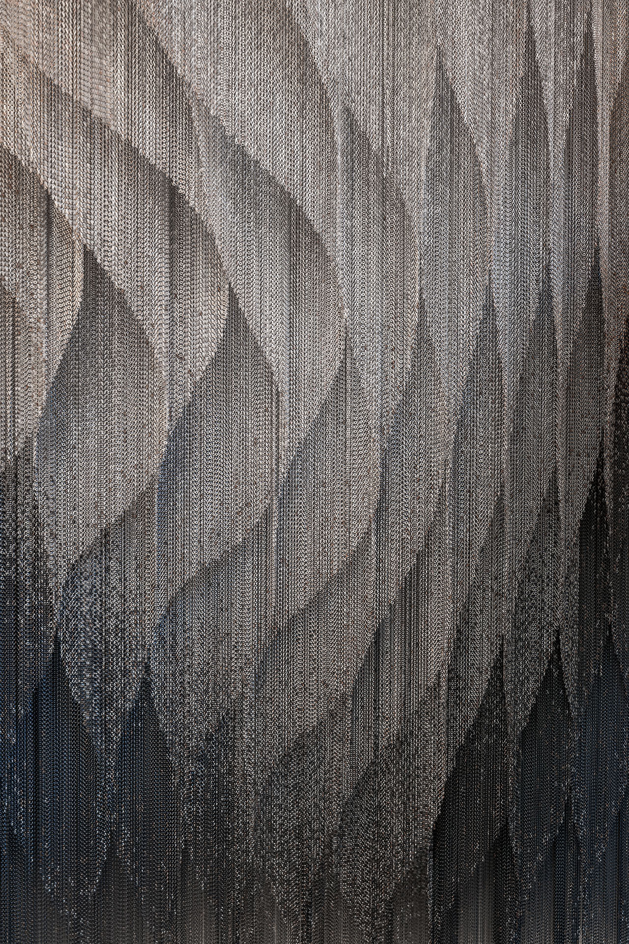 Casa Batlló Stairs & Atrium by Kengo Kuma — A close-up detail of the cascading aluminum chain curtains installed within Casa Batlló's stairwell.