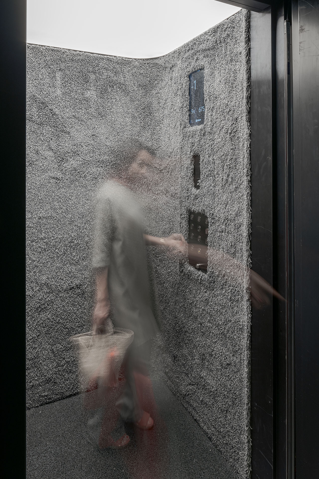 Casa Batlló Stairs & Atrium by Kengo Kuma — A figure navigates the aluminum chain curtain installation, their silhouette fractured by cascading metallic mesh.