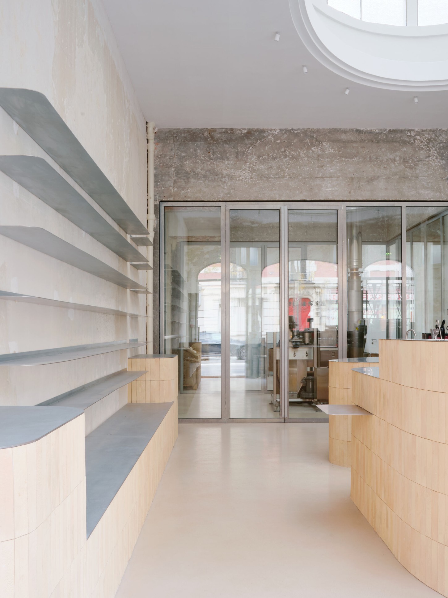 Anbassa by Office Abrami Rojas by Office Abrami Rojas (OAR) — A narrow passage in the Anbassa café interior frames the transition between service and seating zones.