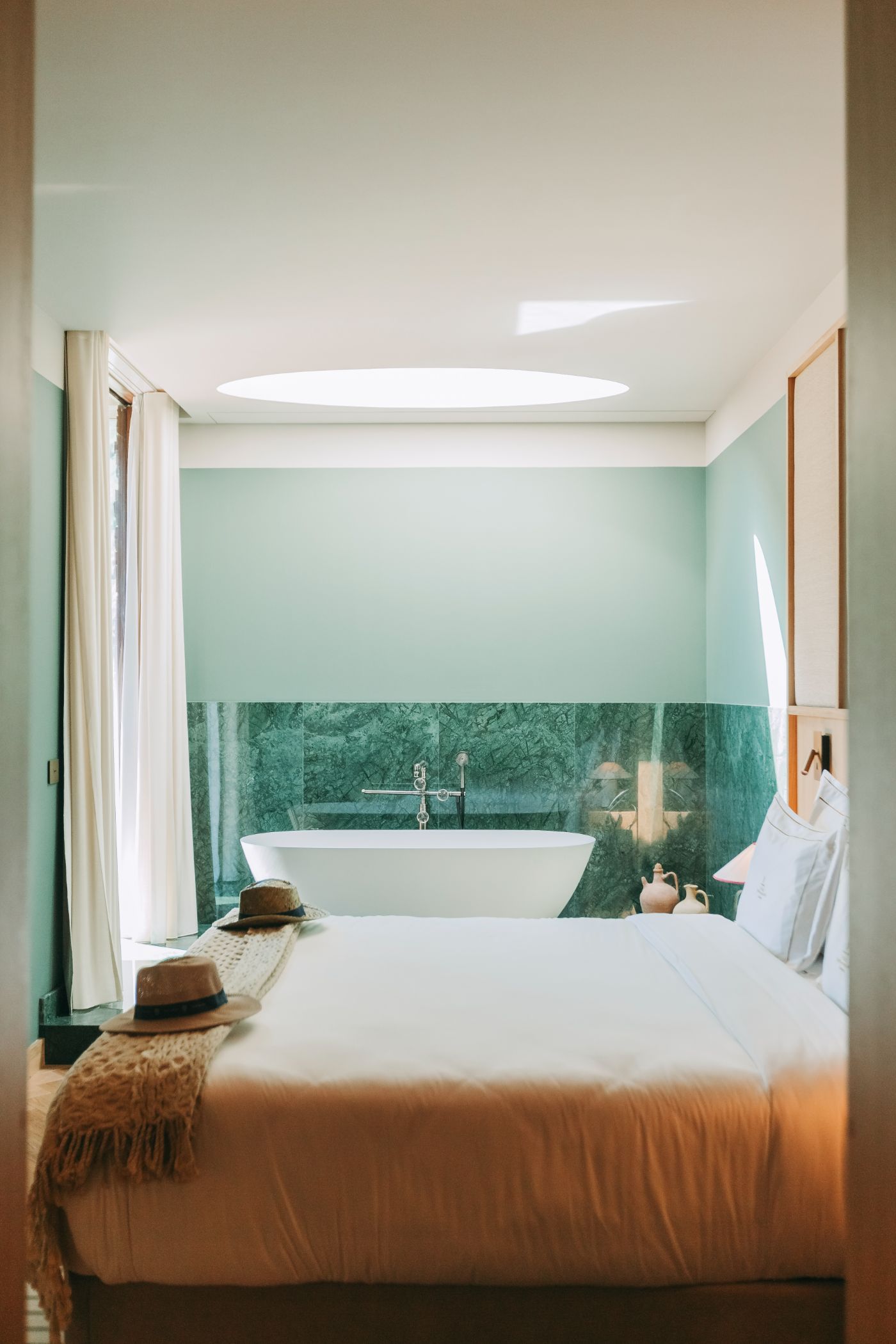 Torel Quinta da Vacaria in Douro Valley by Studio Astolfi and architect Luís Miguel Oliveira — A bedroom-bathroom threshold unified by continuous materiality and color.