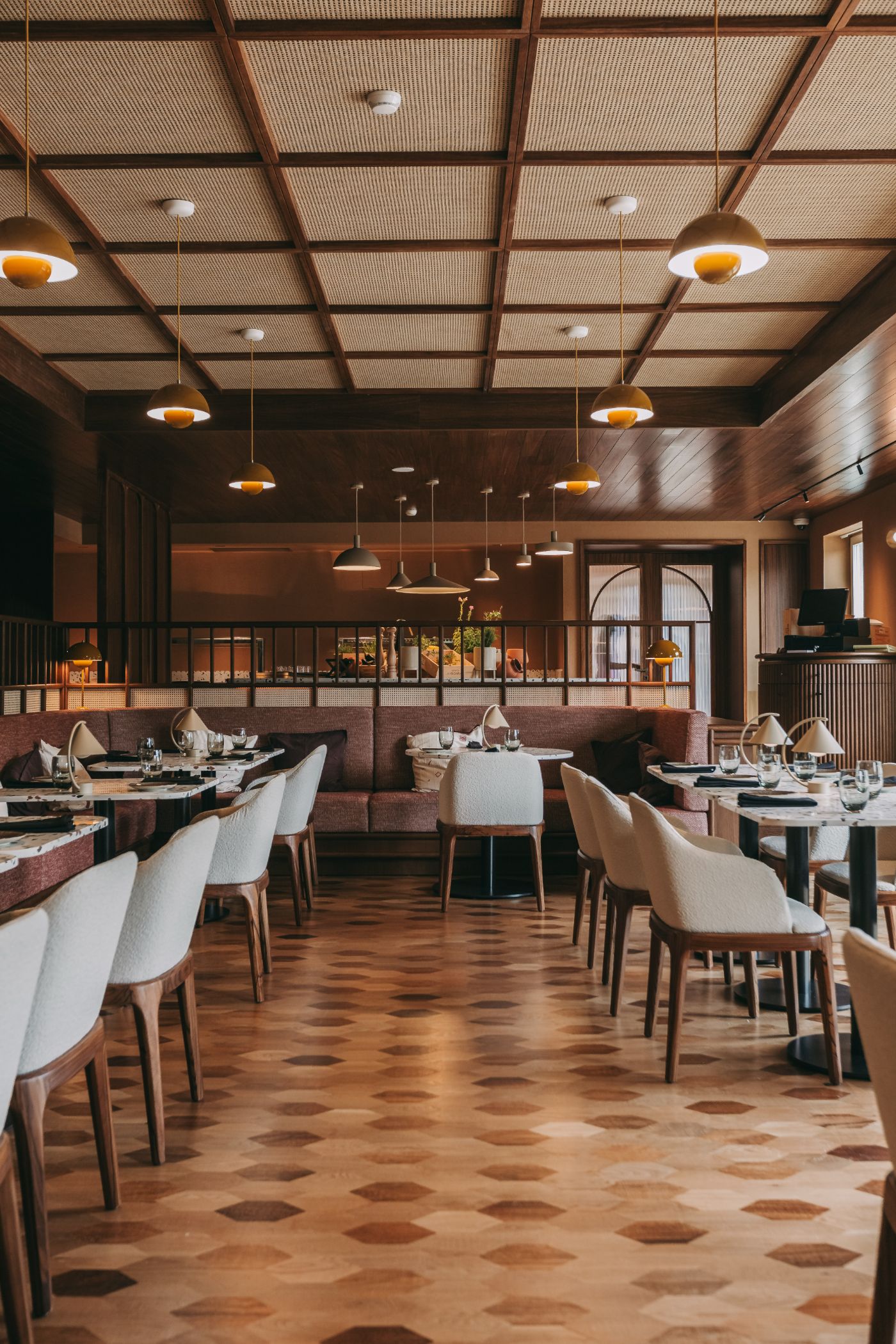 Torel Quinta da Vacaria in Douro Valley by Studio Astolfi and architect Luís Miguel Oliveira — The dining room at Torel Quinta da Vacaria presents a unified material palette centered on warm timber and terracotta tones.