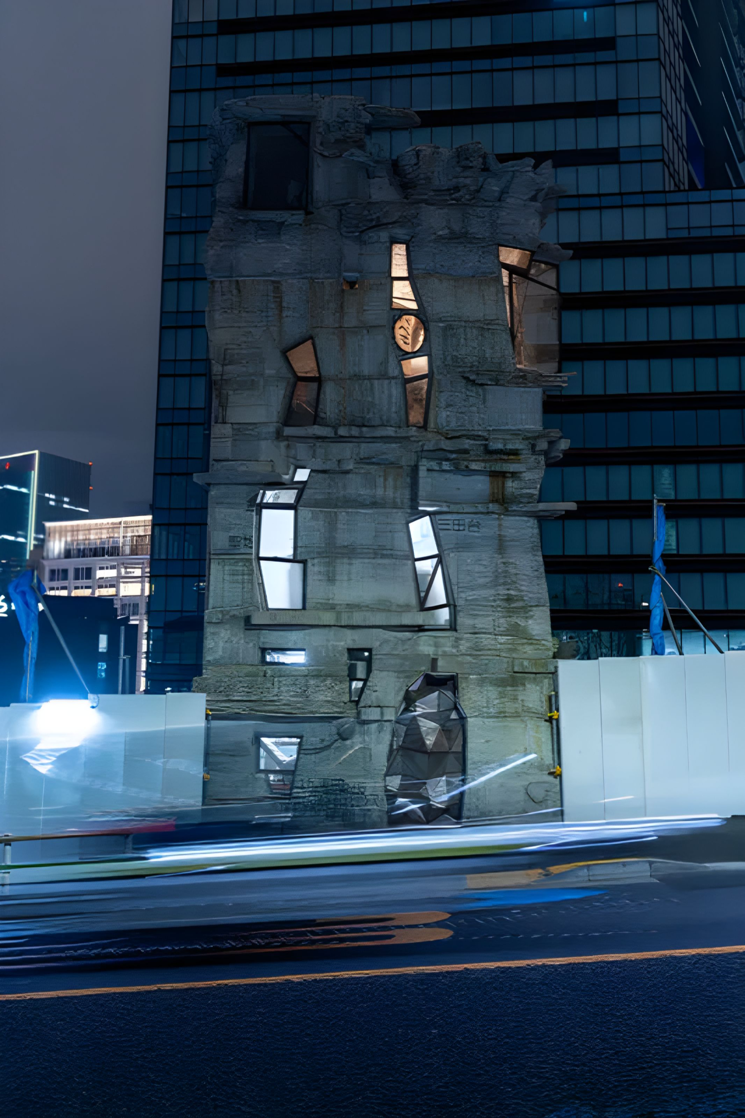 Arimaston Building by Keisuke Oka — Night photograph of the Arimaston Building's facade, captured during twilight with artificial lighting activating the structure's interior.