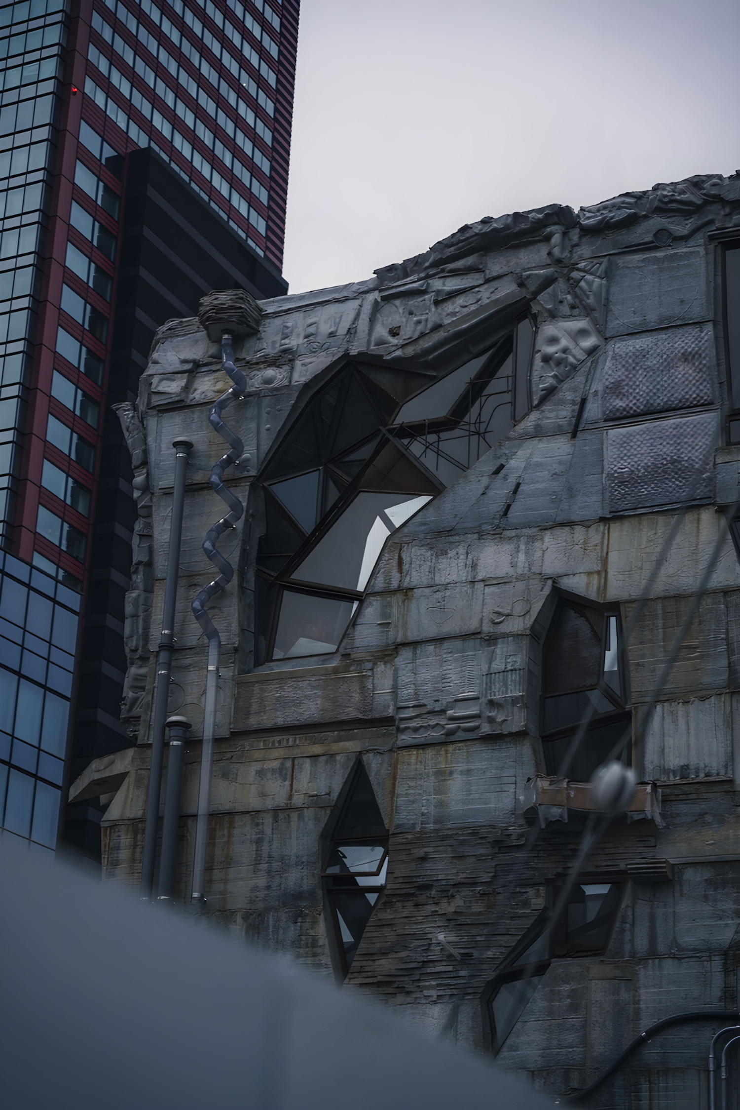Arimaston Building by Keisuke Oka — Keisuke Oka's Arimaston Building presents its weathered concrete facade at close range, revealing the materiality of two decades of exposure.