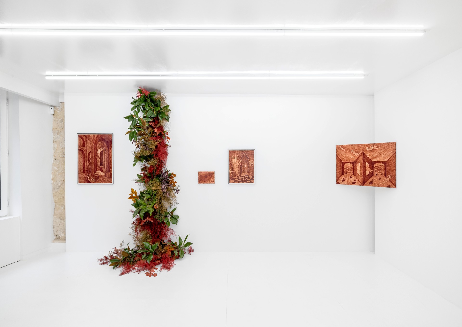 Solve & Coagula by Alison Flora at DS Galerie by Thomas Havet — A vertical living installation anchors the gallery space, its cascading foliage in rust, crimson, and golden tones descending from ceiling to floor where...