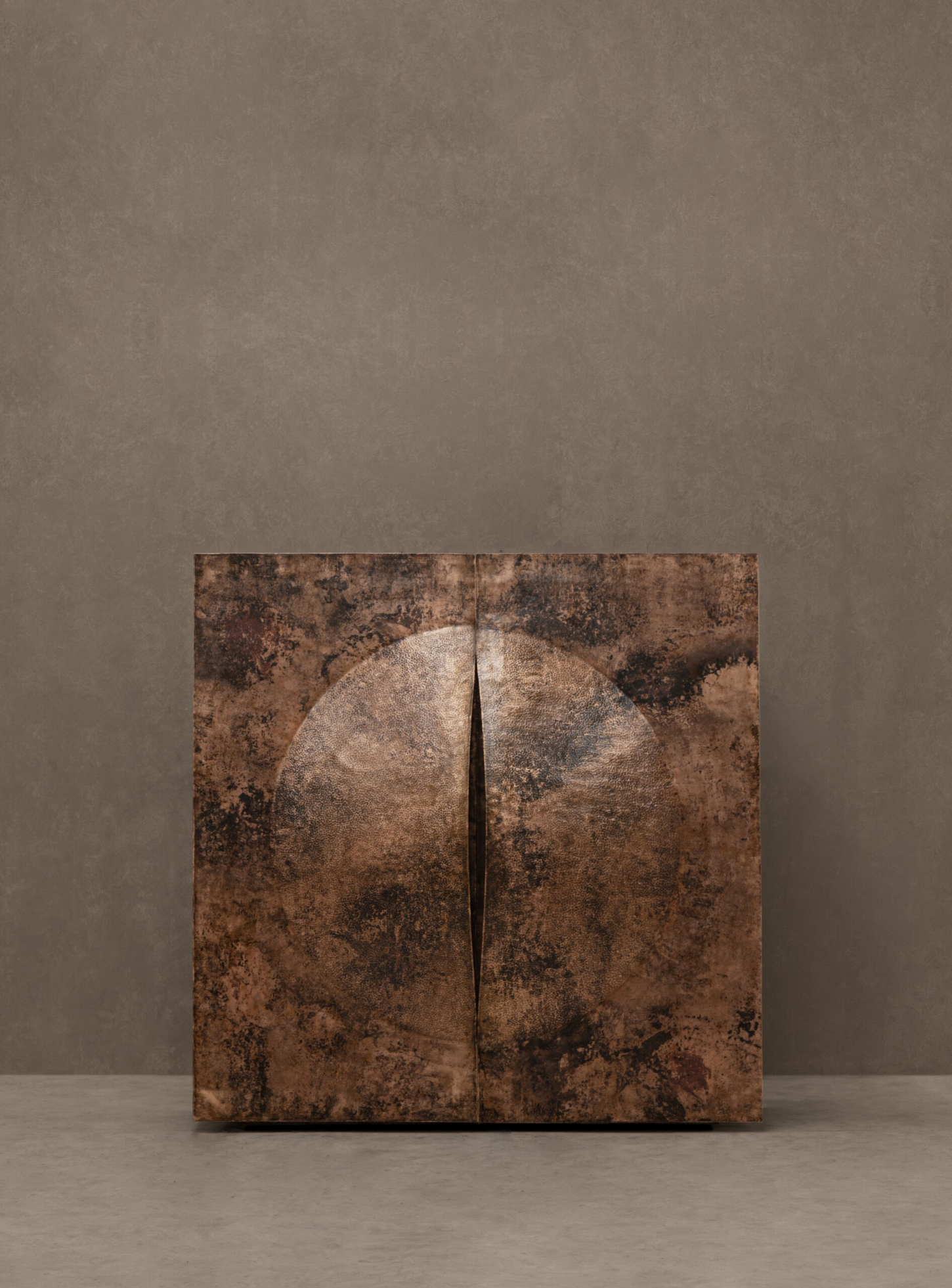 New Works by Manu Bañó — Manu Bañó's polished copper object presents a symmetrical composition divided by a vertical seam.