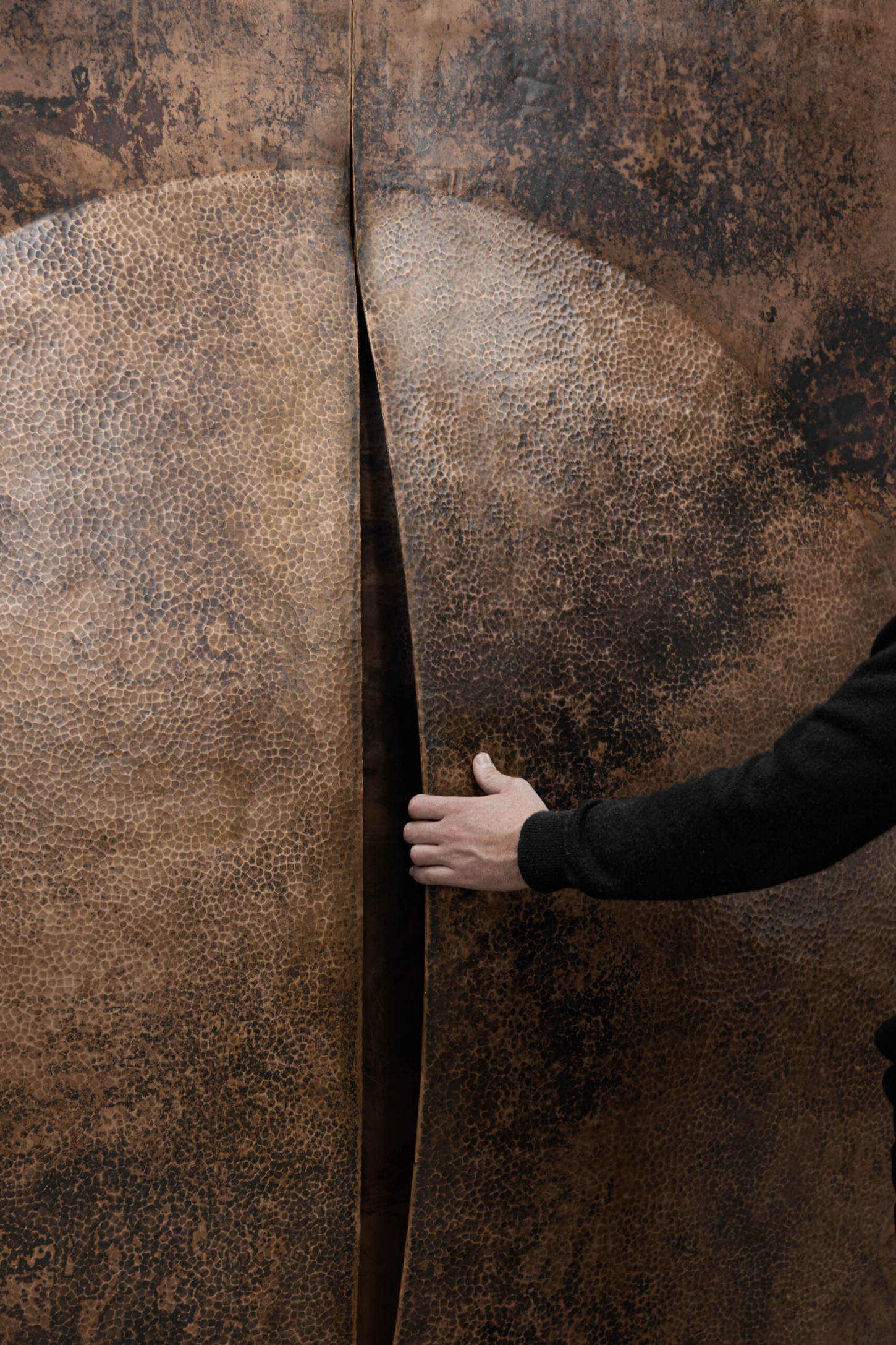 New Works by Manu Bañó — A close-up detail of Manu Bañó's polished copper form reveals the material's dual character.