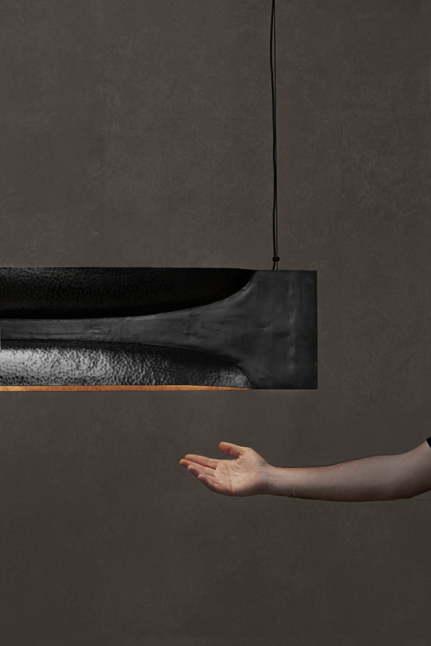 New Works by Manu Bañó — A suspended copper object demonstrates the material's dual character through a vertically seamed composition.