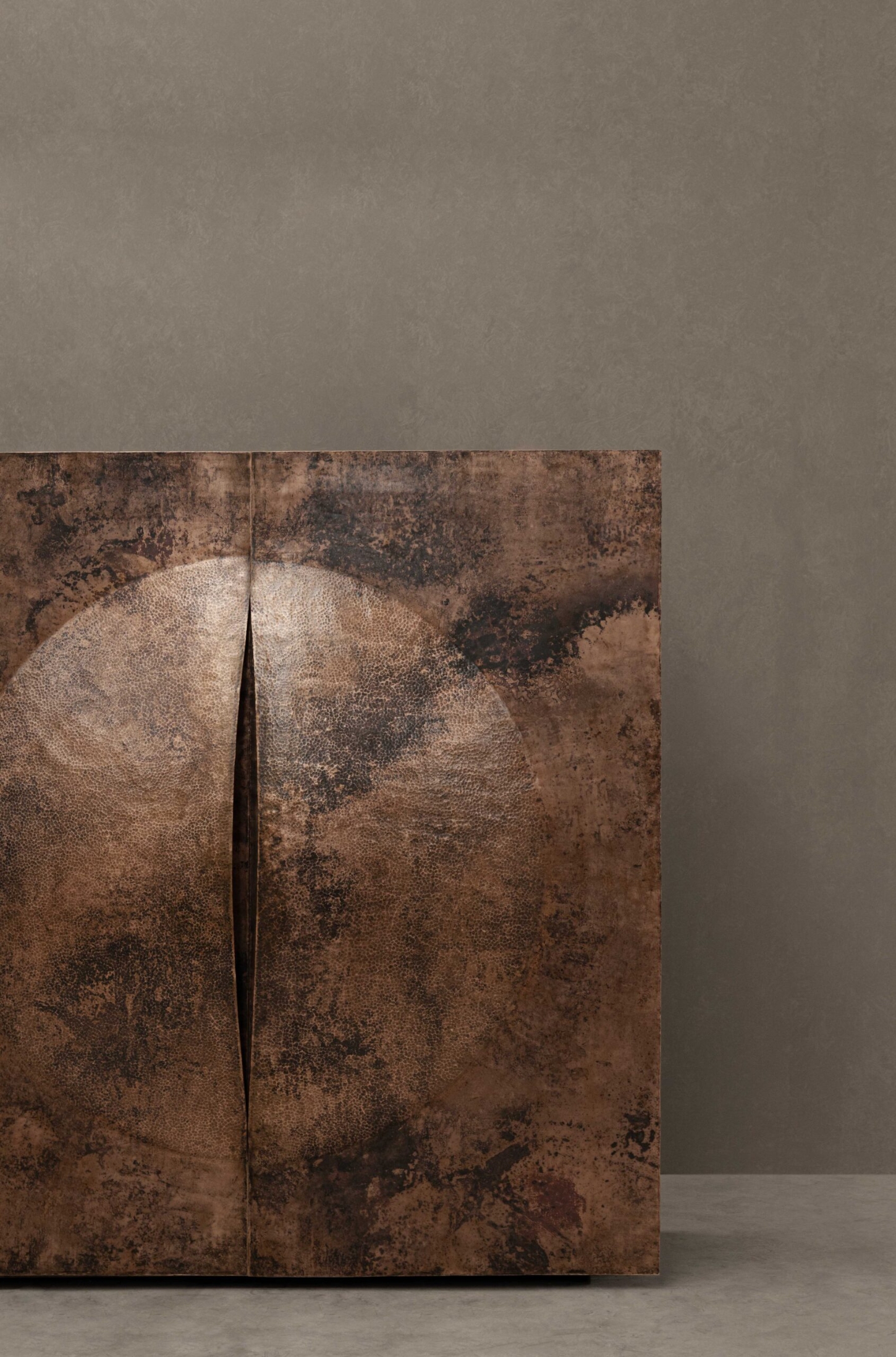 New Works by Manu Bañó — A polished copper dome rises from a fire-tempered metal sheet, its convex surface mirroring light across oxidized patina.