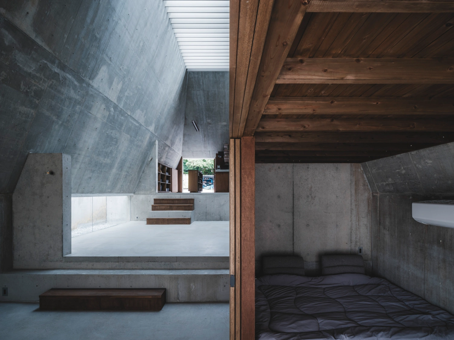 Pyramid Hut by IGArchitects — This interior perspective reveals the spatial hierarchy within Pyramid Hut's monolithic concrete envelope.