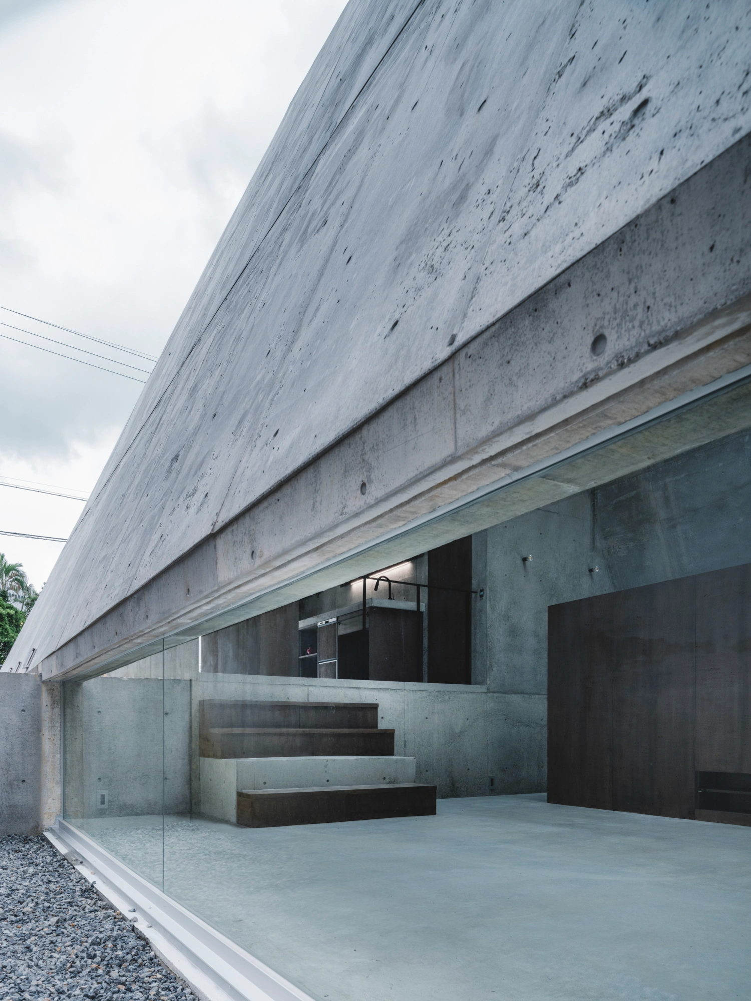 Pyramid Hut by IGArchitects — The ground-floor facade presents a studied dialogue between materiality and concealment.
