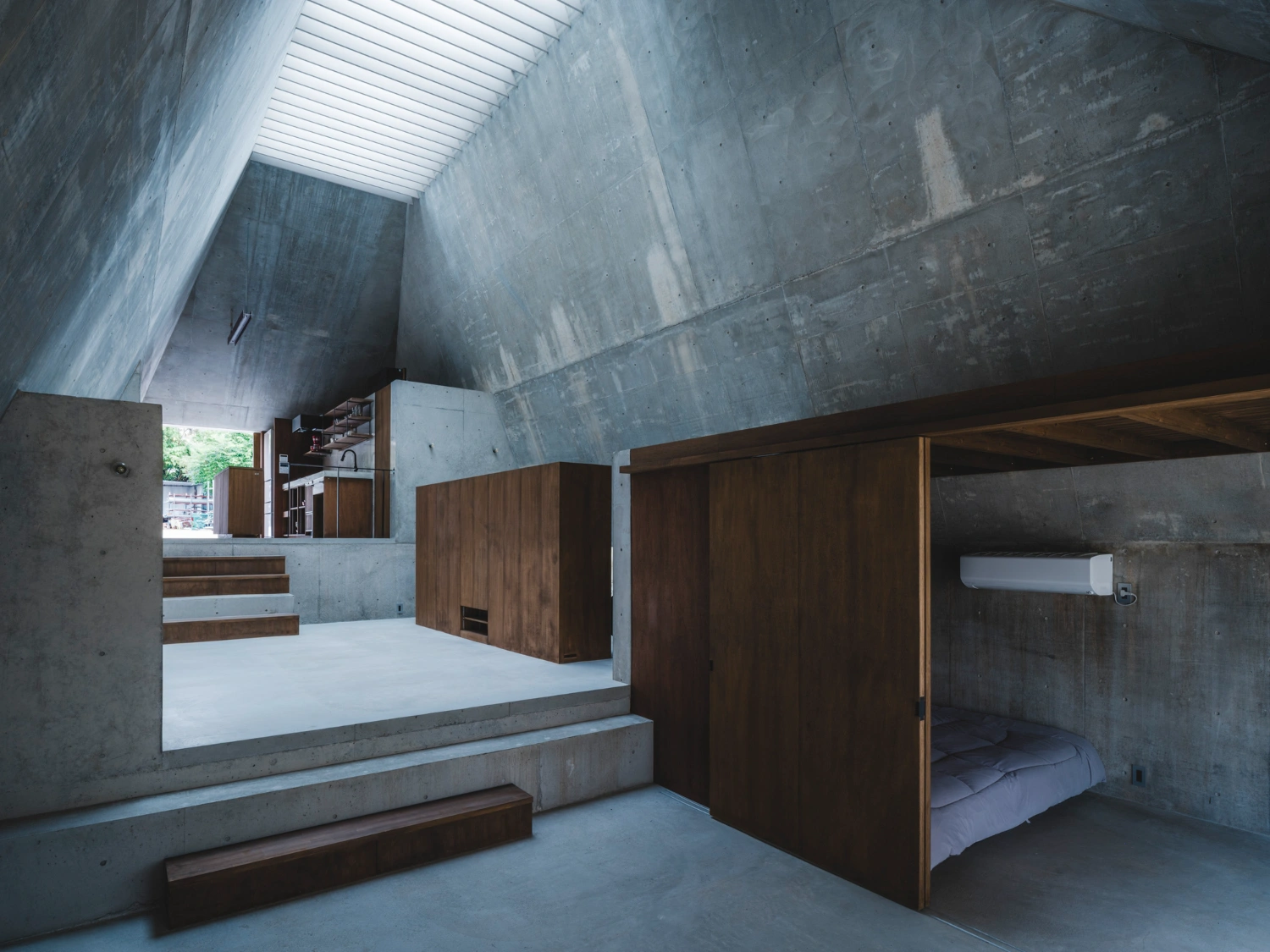 Pyramid Hut by IGArchitects — Interior view of Pyramid Hut revealing the spatial organization within the concrete envelope.