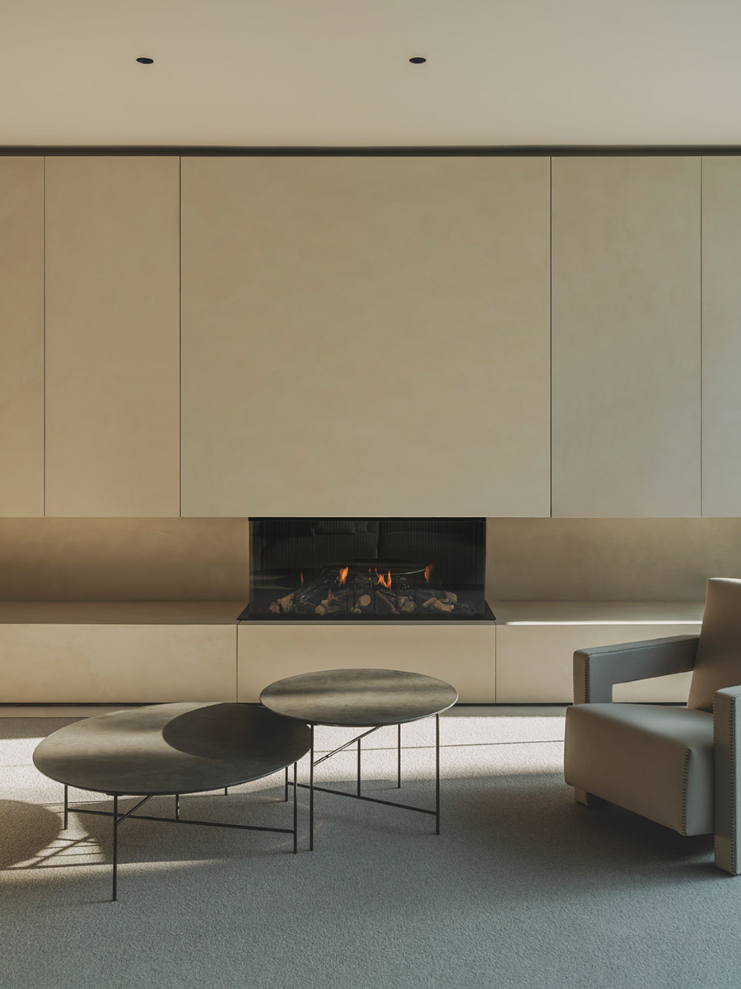 S29 House by Francesc Rifé Studio + Exit Projectes — A minimalist living space centered on a linear gas fireplace with black surround and visible flames.