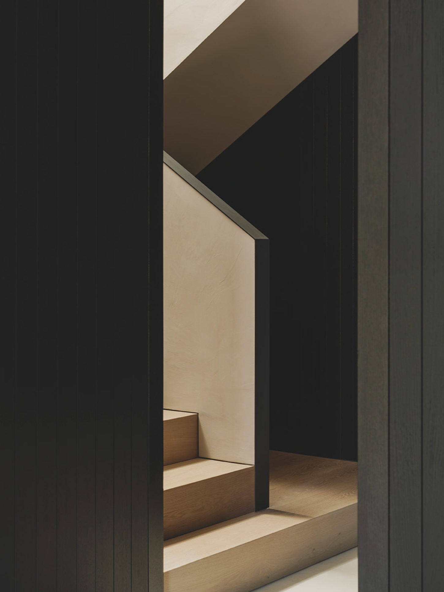 S29 House by Francesc Rifé Studio + Exit Projectes — A threshold perspective reveals the spatial layering of S29 House through successive dark timber frames.