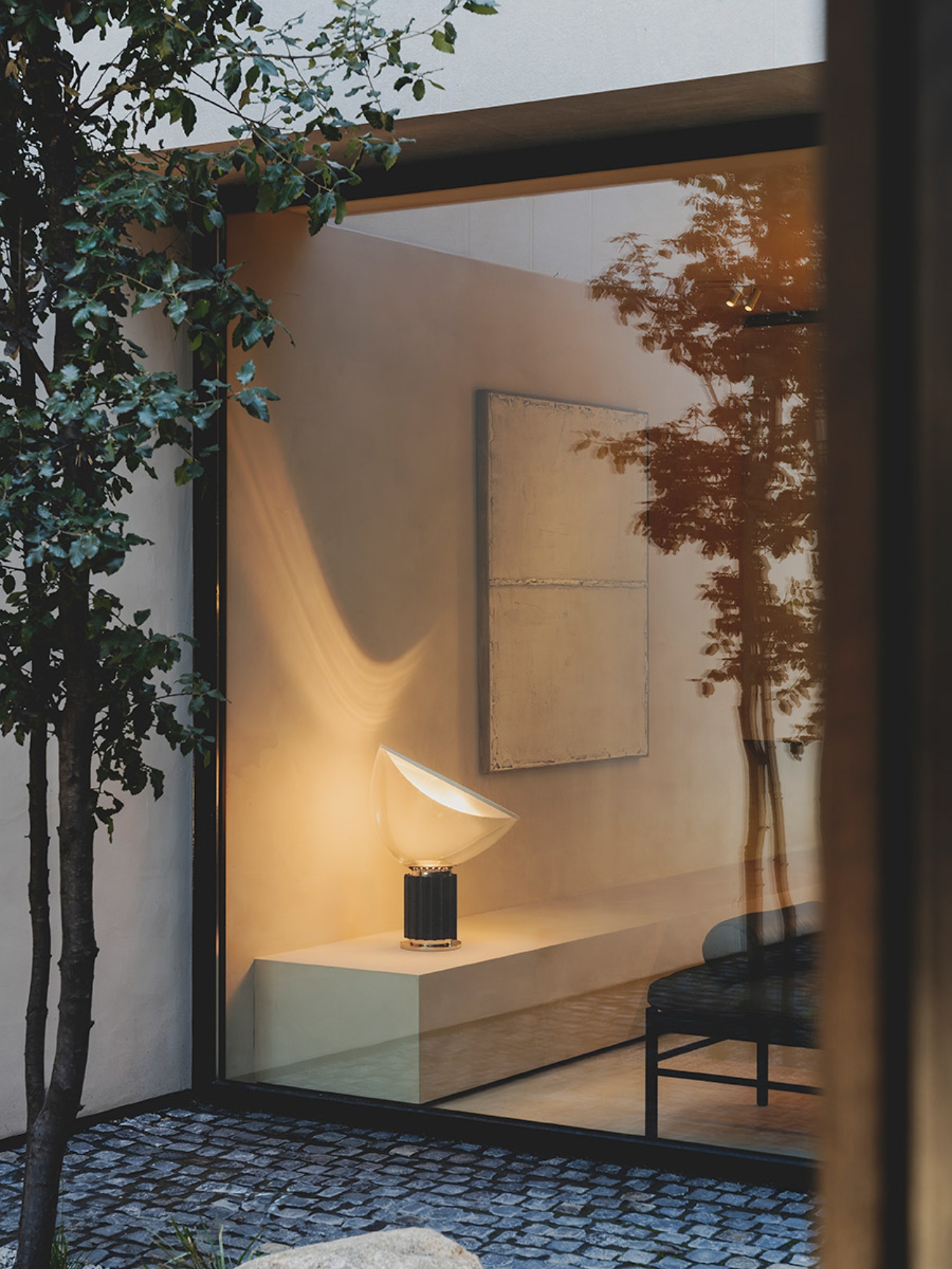 S29 House by Francesc Rifé Studio + Exit Projectes — A threshold view into a minimalist interior alcove framed by dark timber structural beam.