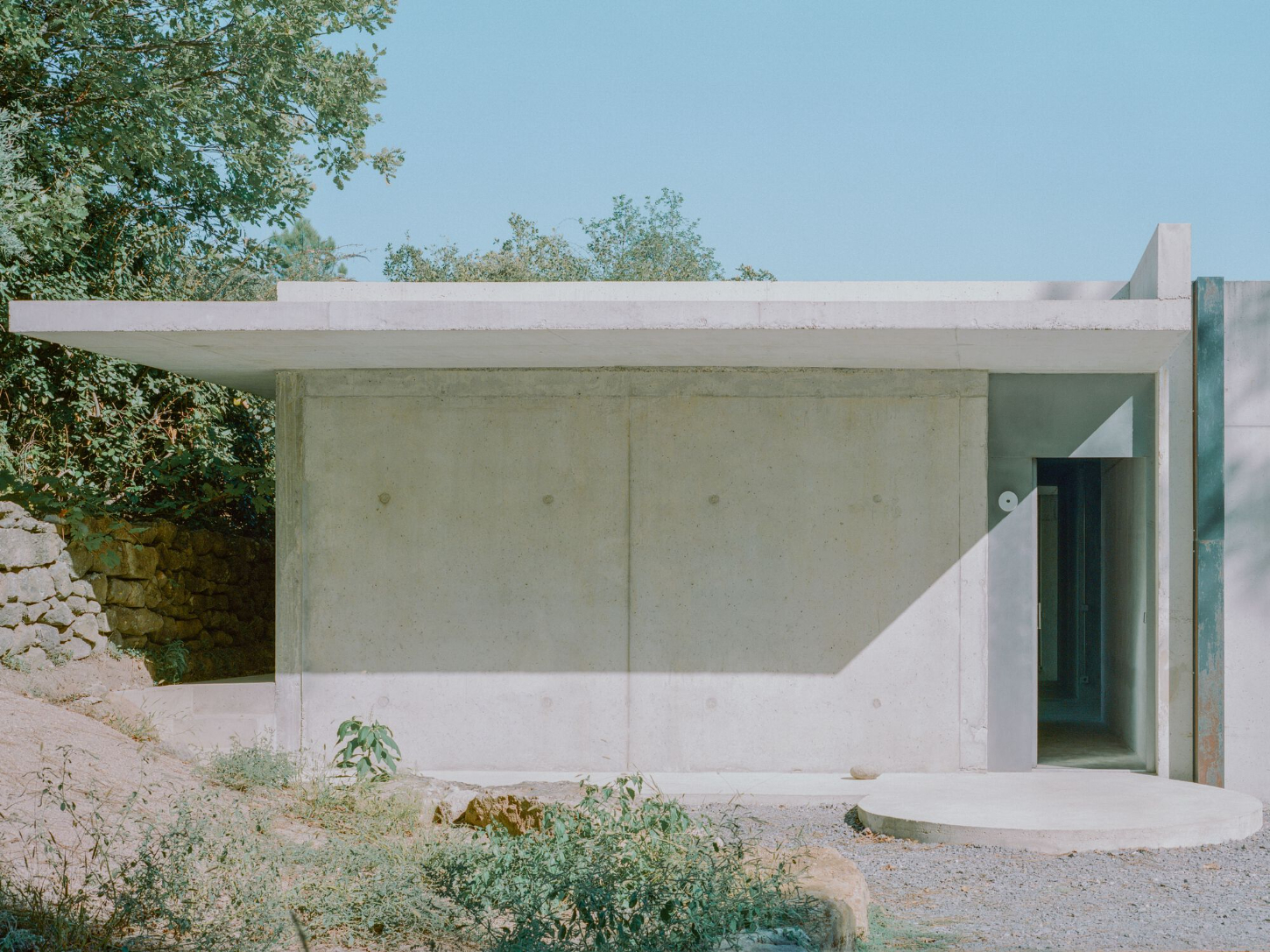 PAYZ House by Alors Studio — The PAYZ House presents itself as a monolithic concrete volume set against the Payzac landscape.