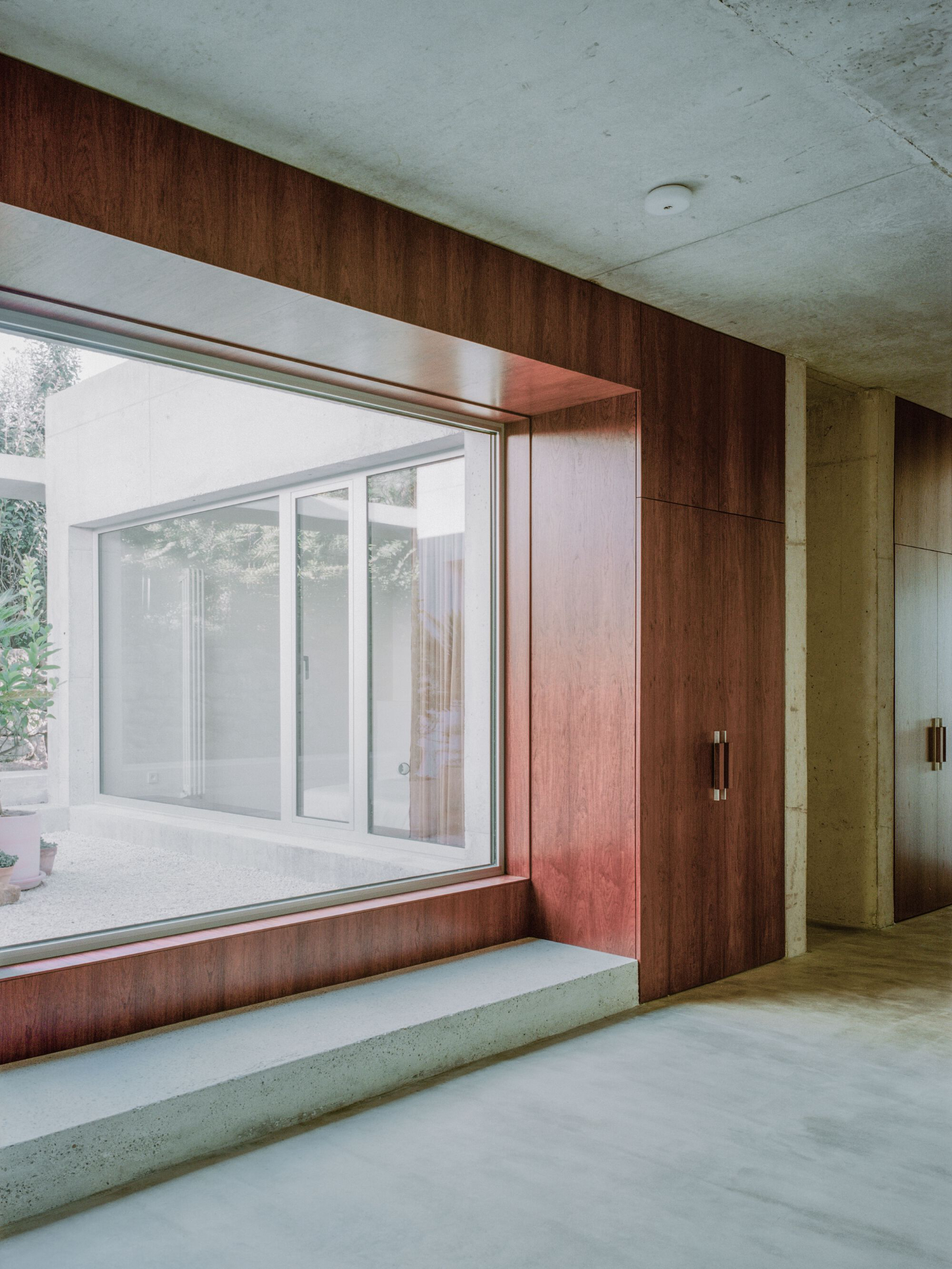 PAYZ House by Alors Studio — A threshold composition framing the bedroom as a framed interior landscape.