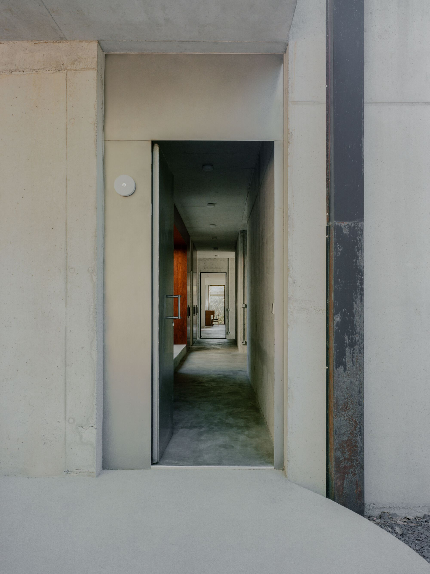 PAYZ House by Alors Studio — A deep-focus corridor photograph reveals the layered spatial sequence of the PAYZ House interior.