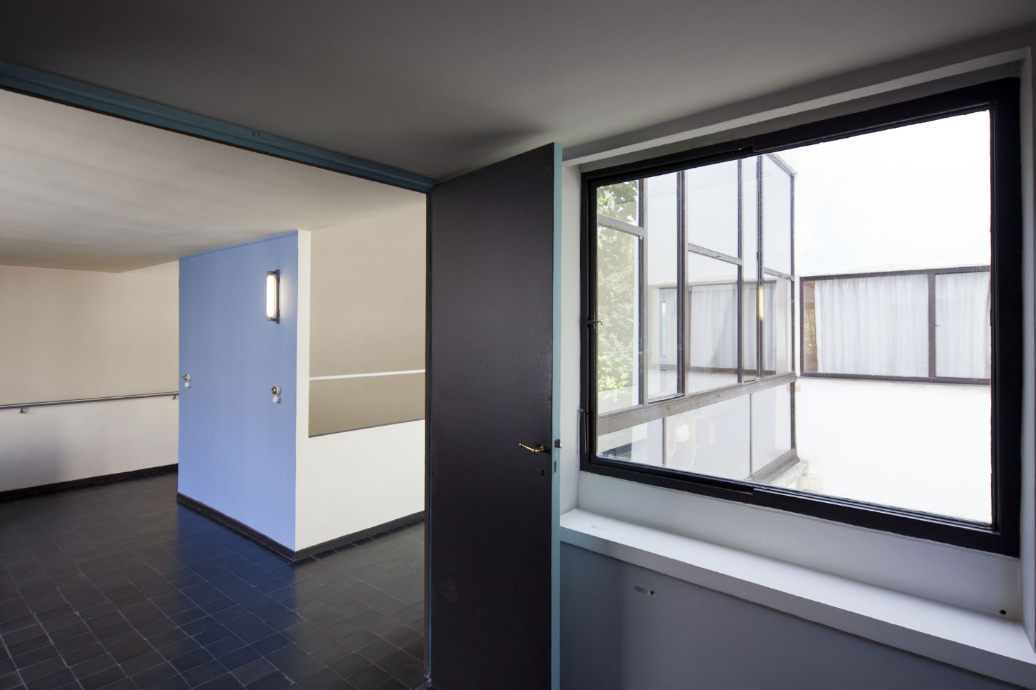 Maison La Roche-Jeanneret by Le Corbusier by Le Corbusier and Pierre Jeanneret — A corridor within Le Corbusier's Maison La Roche-Jeanneret reveals the architect's systematic approach to spatial division and light control.