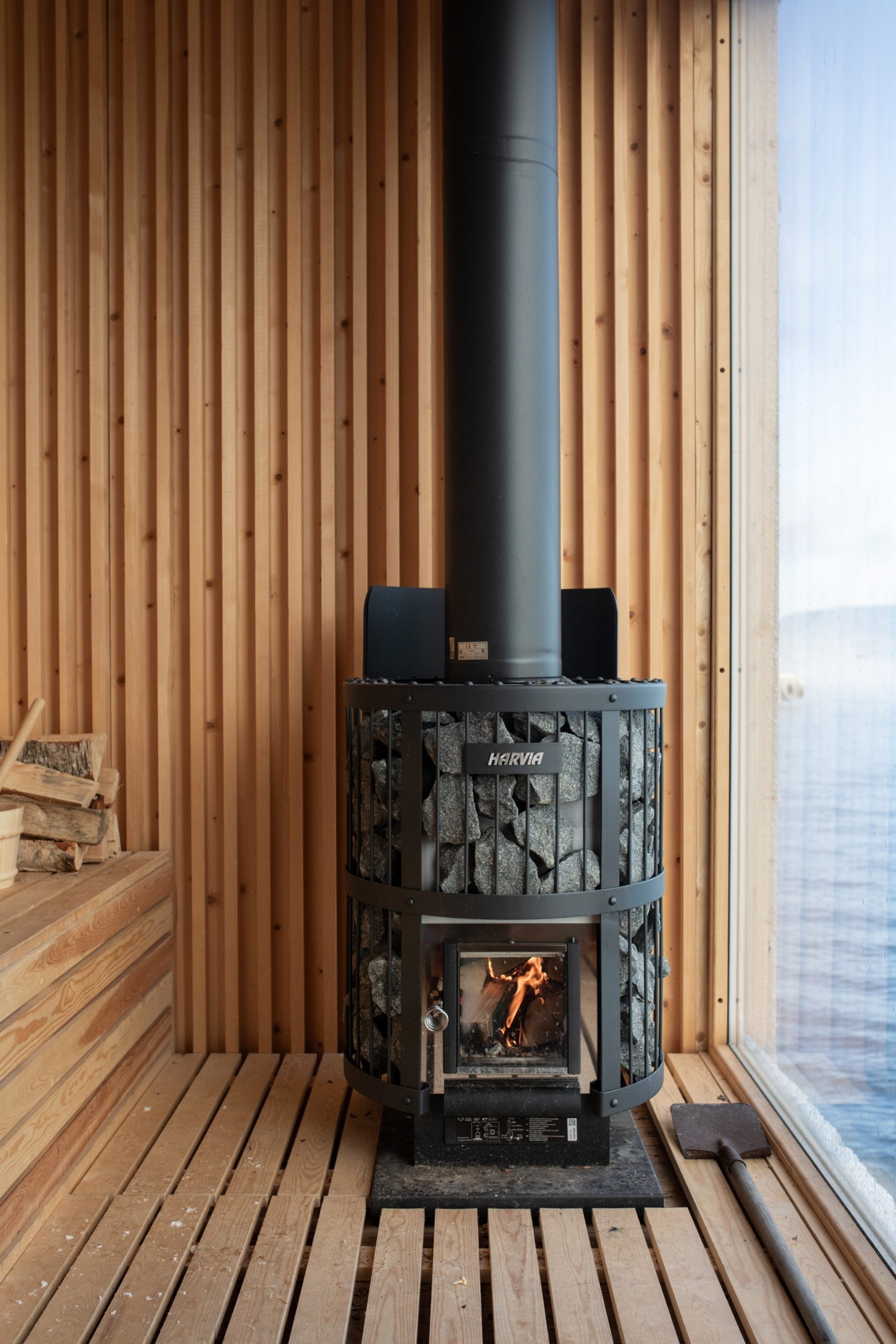 The Hotspot Oslo Works — A wood-fired sauna occupies the interior of this elevated structure on the Nesodden Peninsula, its cylindrical black metal body positioned centrally against...